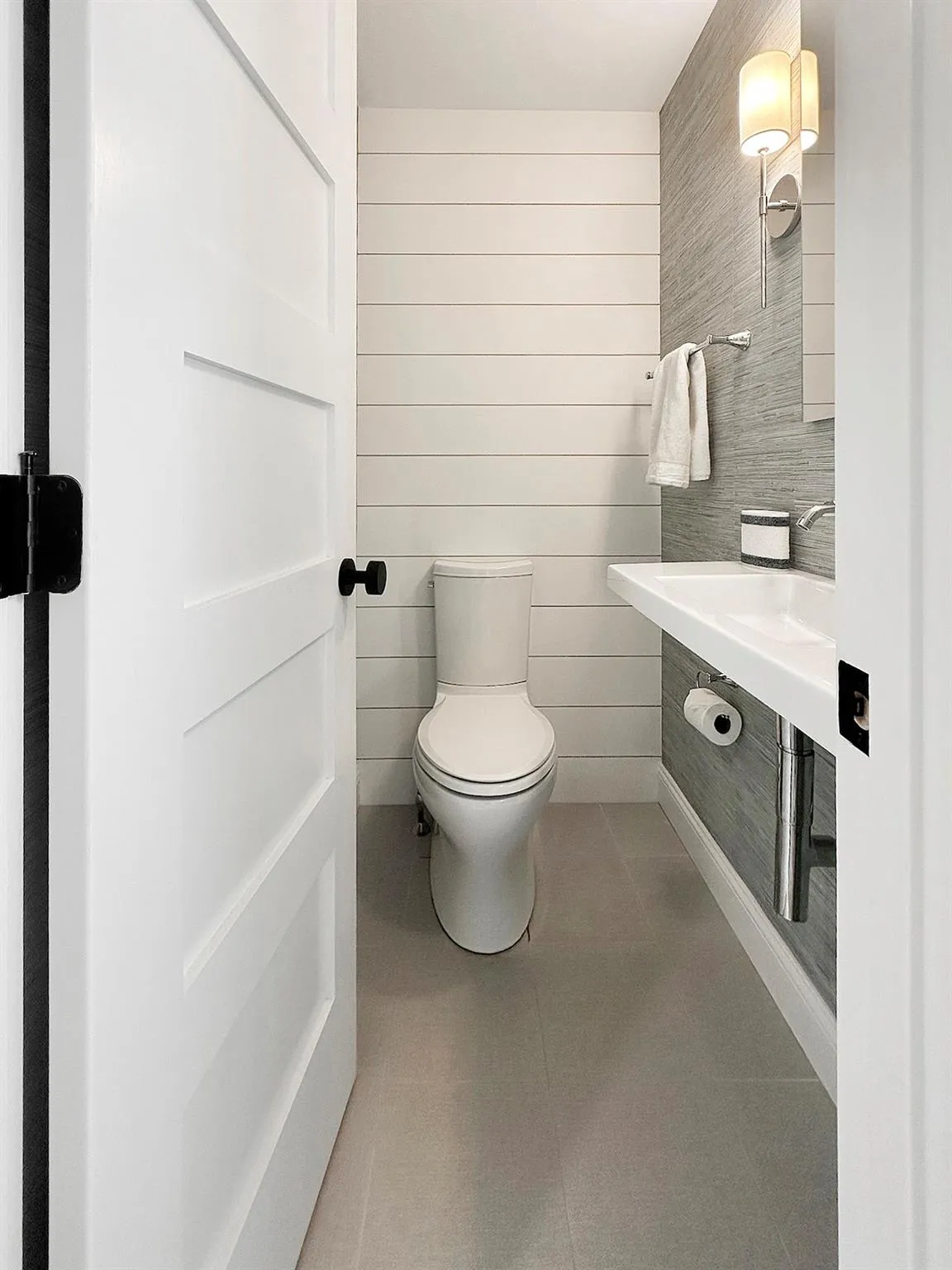Half bathroom featuring toilet and tile patterned floors Half bathroom featuring toilet and tile patterned floors