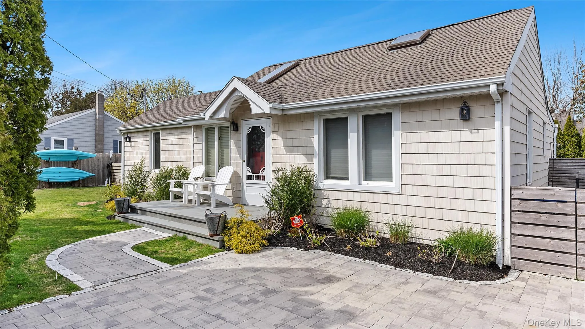 View of front of house featuring a shingled roof, a front yard, and fence View of front of house featuring a shingled roof, a front yard, and fence