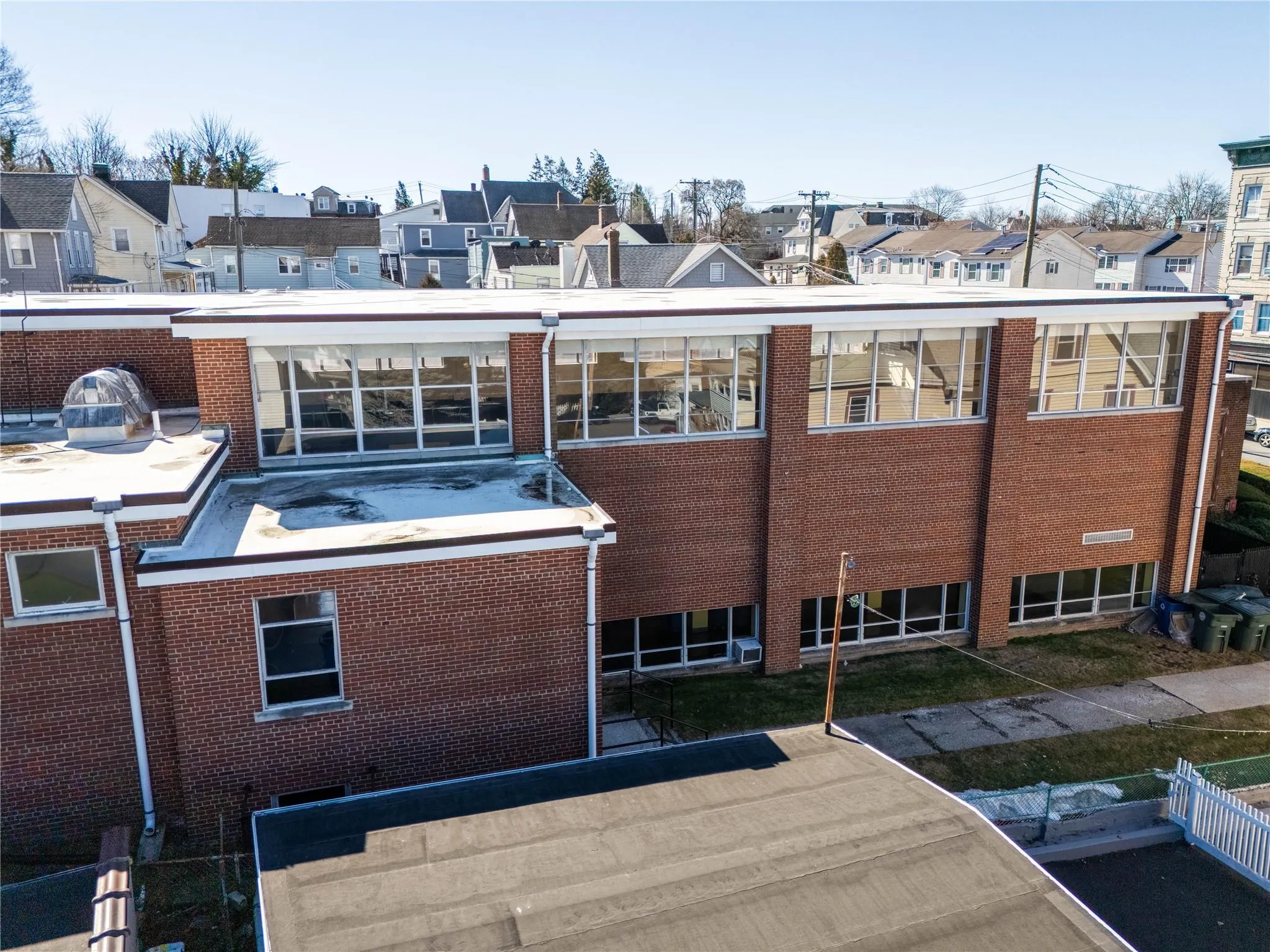 Rear view of property featuring a patio area, a residential view, fence, and brick siding Rear view of property featuring a patio area, a residential view, fence, and brick siding