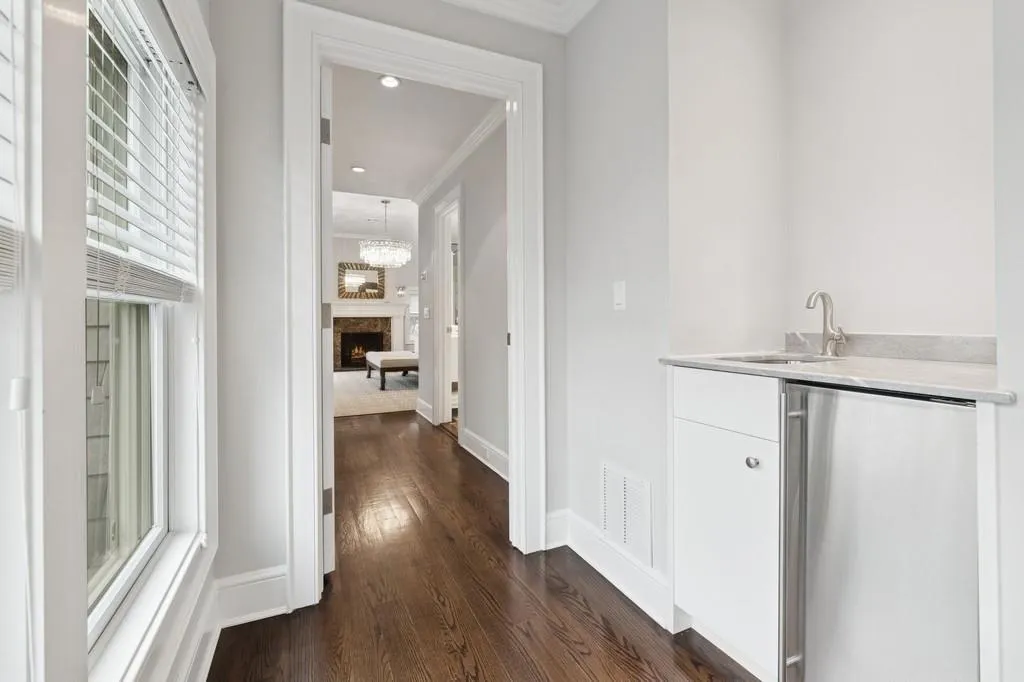 Bar with dark wood-type flooring, baseboards, visible vents, and a sink Bar with dark wood-type flooring, baseboards, visible vents, and a sink