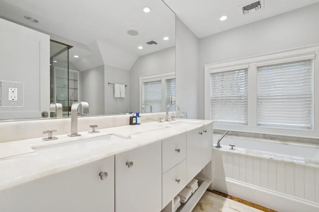 Bathroom featuring double vanity, visible vents, a garden tub, and a sink Bathroom featuring double vanity, visible vents, a garden tub, and a sink