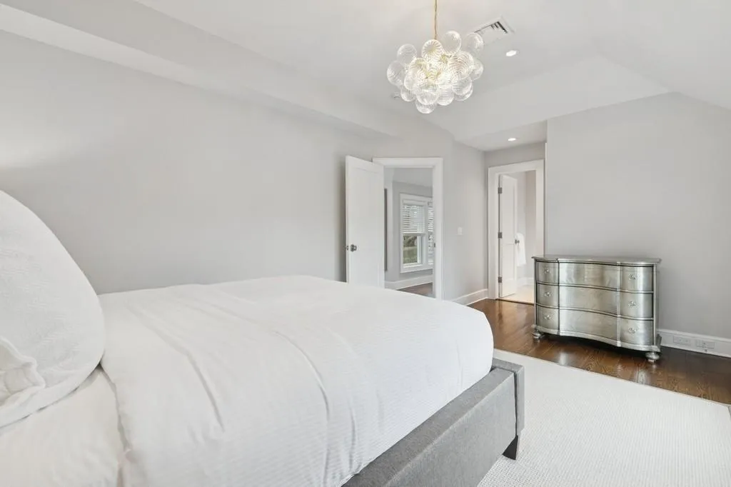 Bedroom with wood finished floors, visible vents, baseboards, recessed lighting, and vaulted ceiling Bedroom with wood finished floors, visible vents, baseboards, recessed lighting, and vaulted ceiling