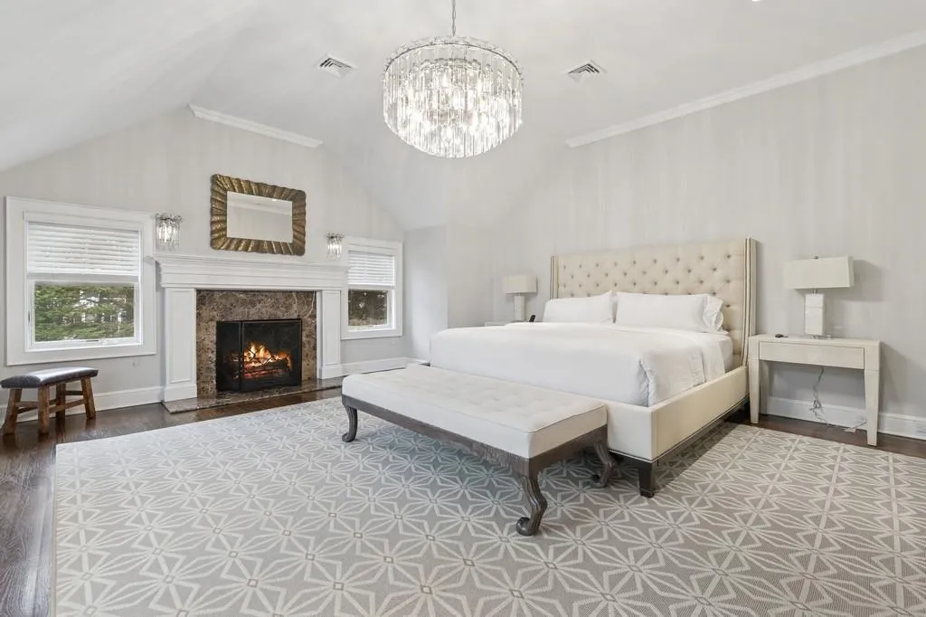 Bedroom featuring vaulted ceiling, multiple windows, and wood finished floors Bedroom featuring vaulted ceiling, multiple windows, and wood finished floors