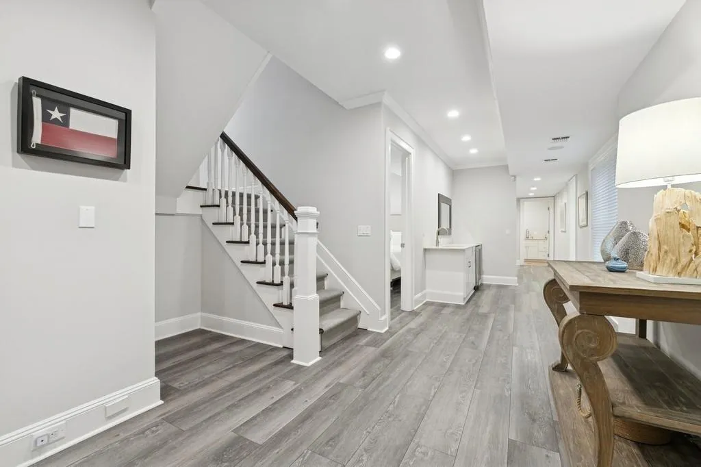 Entrance foyer with wood finished floors, recessed lighting, crown molding, baseboards, and stairs Entrance foyer with wood finished floors, recessed lighting, crown molding, baseboards, and stairs