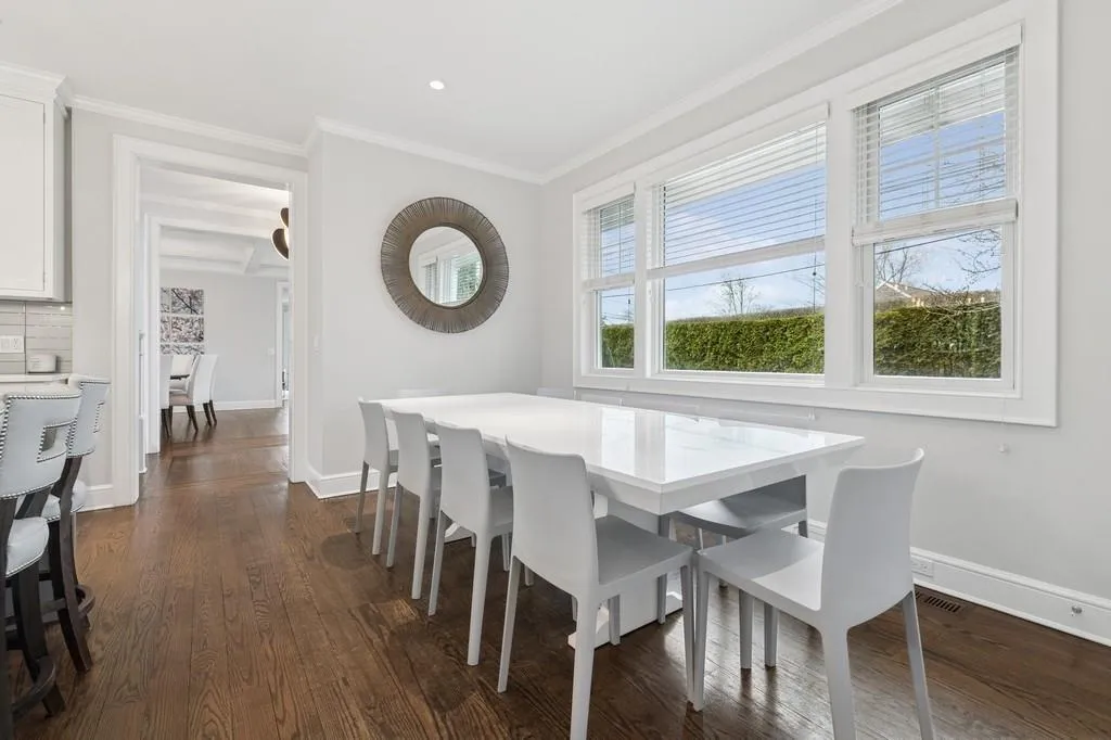 Dining room with baseboards, ornamental molding, and dark wood-style flooring Dining room with baseboards, ornamental molding, and dark wood-style flooring