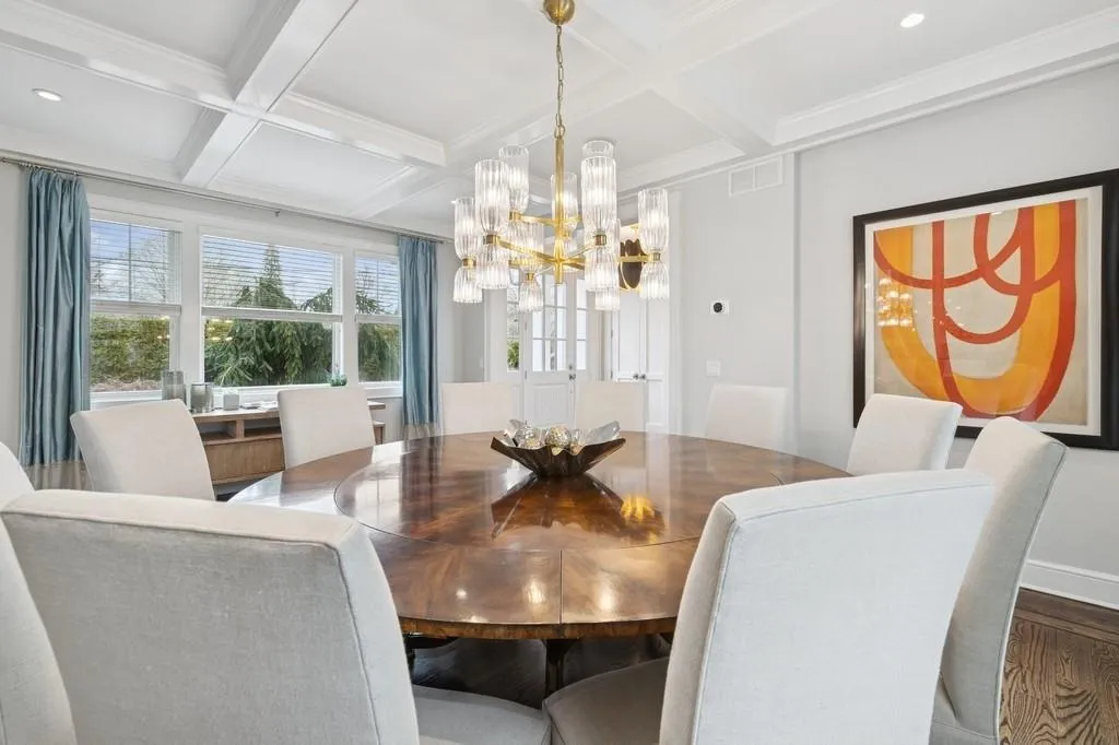 Dining space with beamed ceiling, wood finished floors, and coffered ceiling Dining space with beamed ceiling, wood finished floors, and coffered ceiling