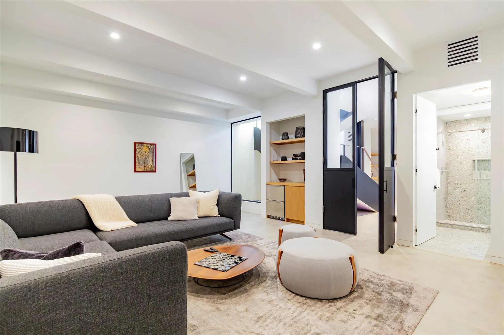 Living room with beamed ceiling, recessed lighting, built in shelves, and visible vents Living room with beamed ceiling, recessed lighting, built in shelves, and visible vents