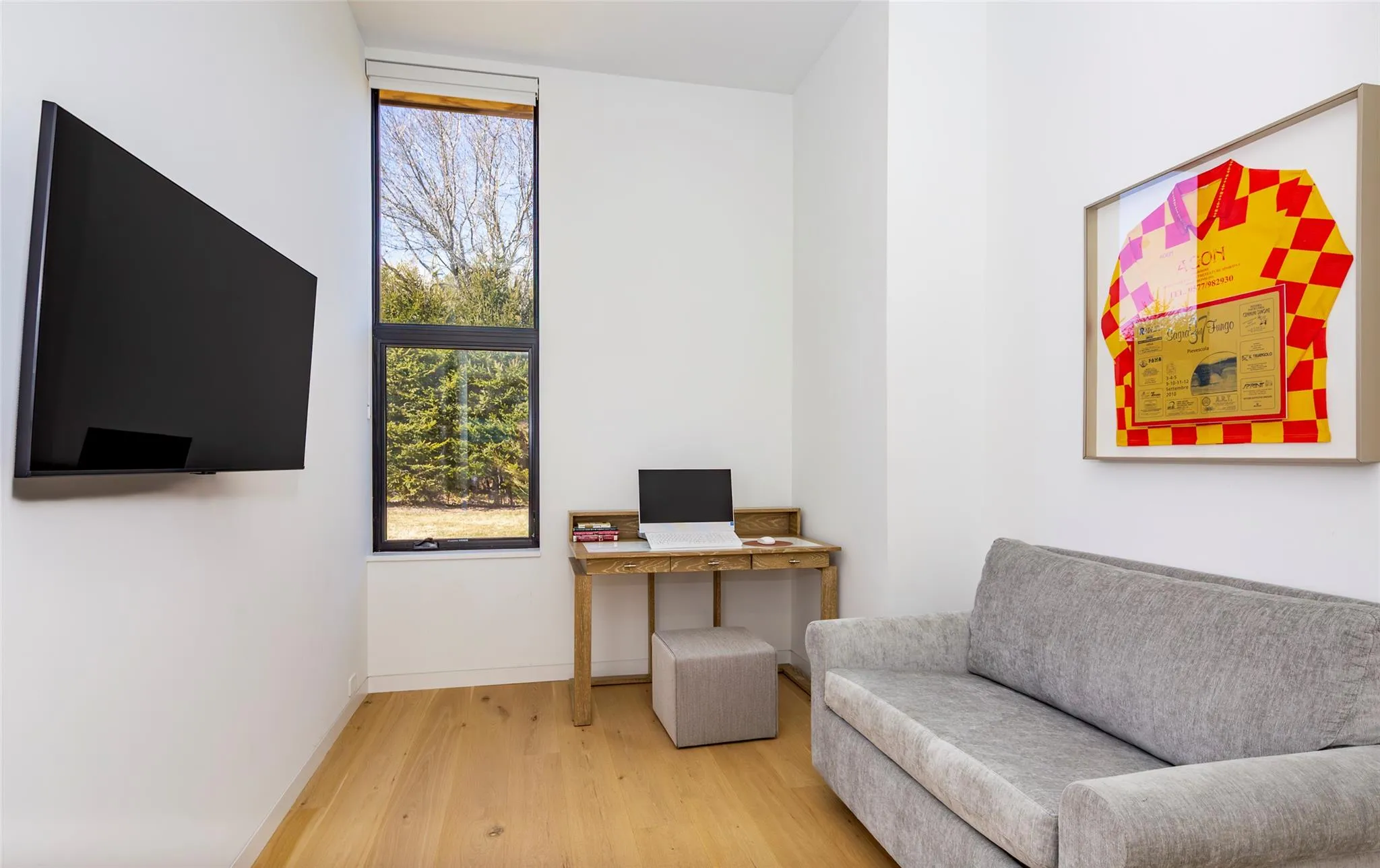 Living area featuring baseboards and light wood-style floors Living area featuring baseboards and light wood-style floors