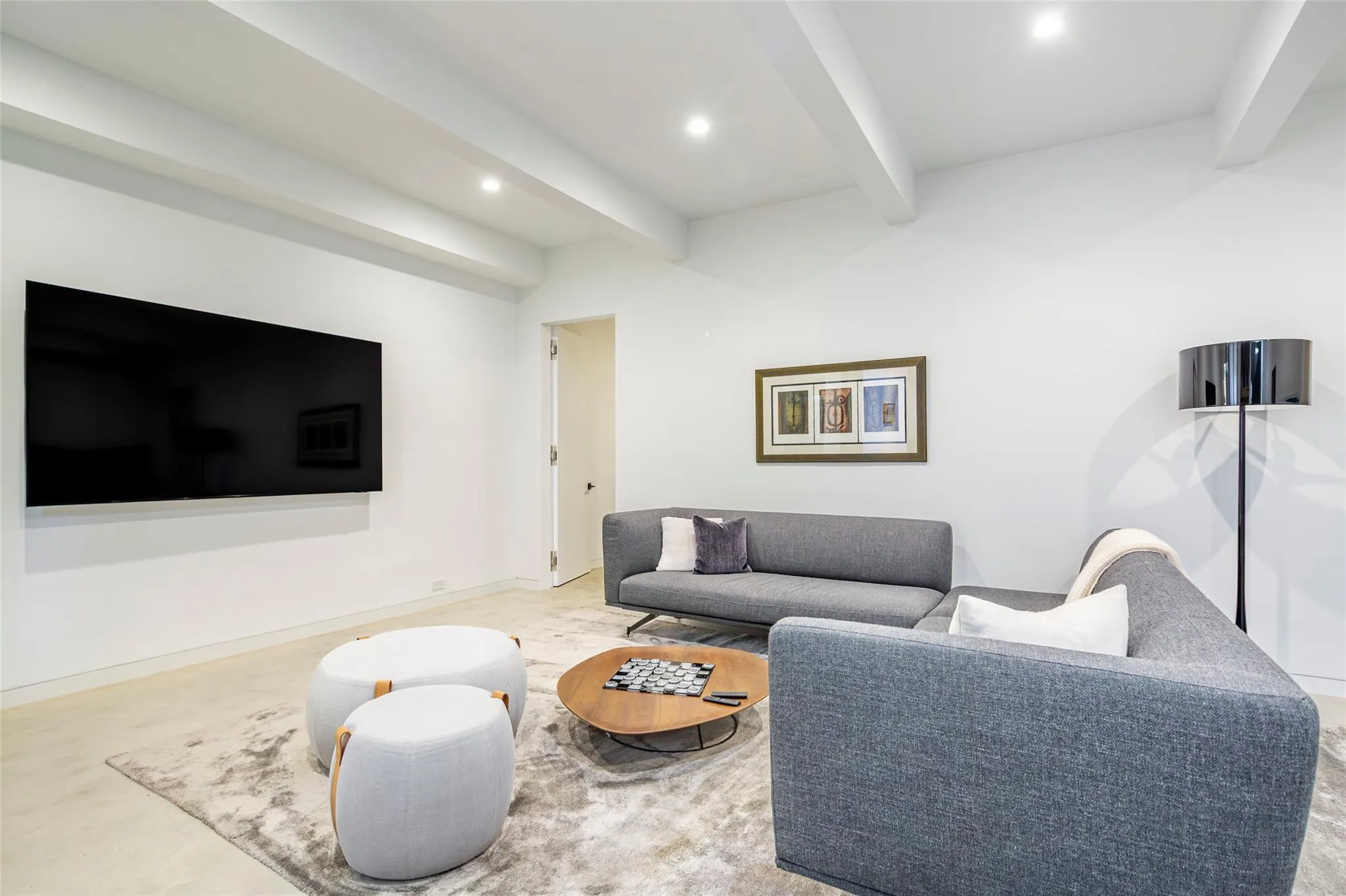 Living area featuring recessed lighting, baseboards, and beam ceiling Living area featuring recessed lighting, baseboards, and beam ceiling