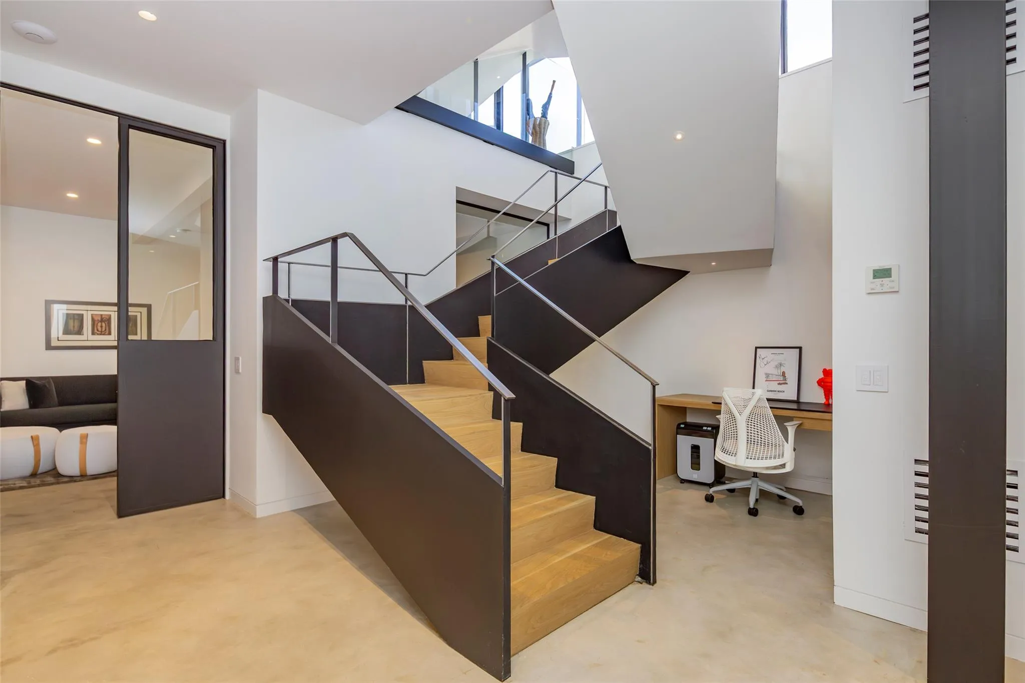 Stairs with recessed lighting, built in desk, concrete floors, and baseboards Stairs with recessed lighting, built in desk, concrete floors, and baseboards
