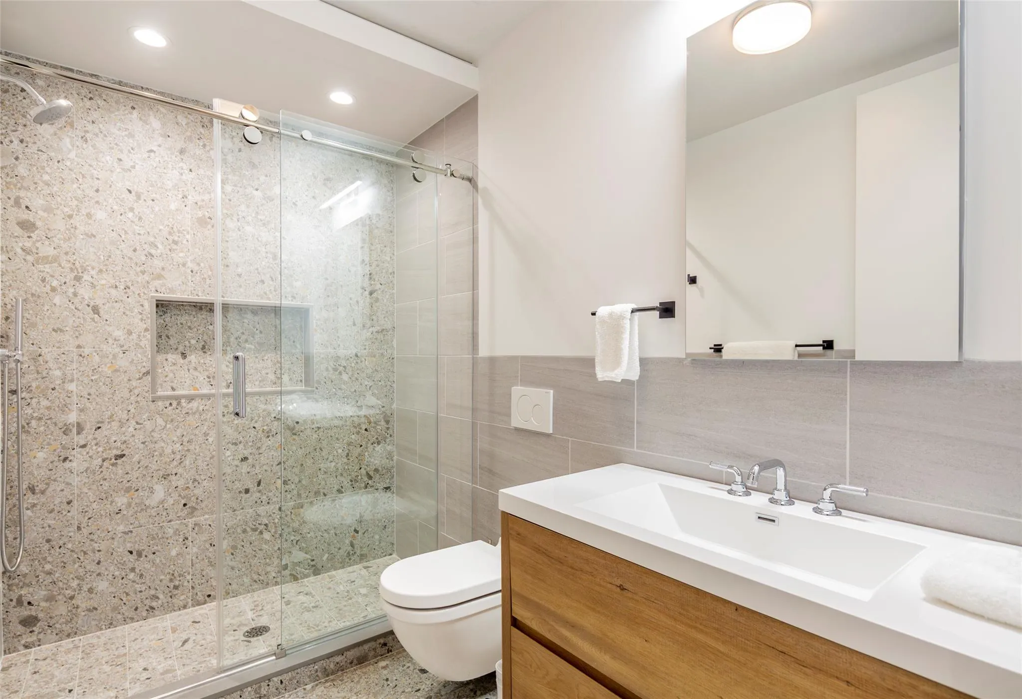 Bathroom with toilet, recessed lighting, tile walls, a shower stall, and vanity Bathroom with toilet, recessed lighting, tile walls, a shower stall, and vanity