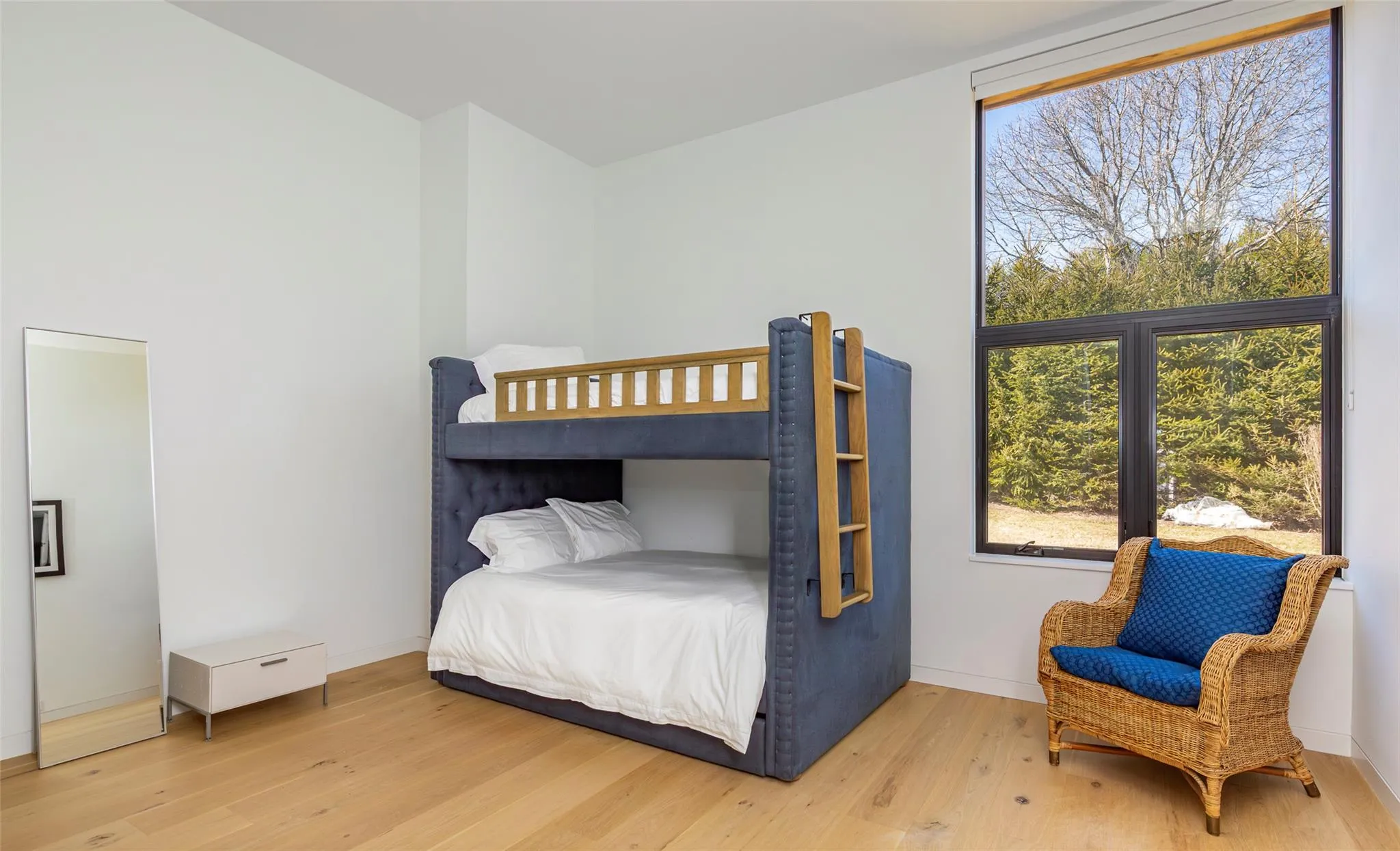 Bedroom featuring baseboards and light wood finished floors Bedroom featuring baseboards and light wood finished floors