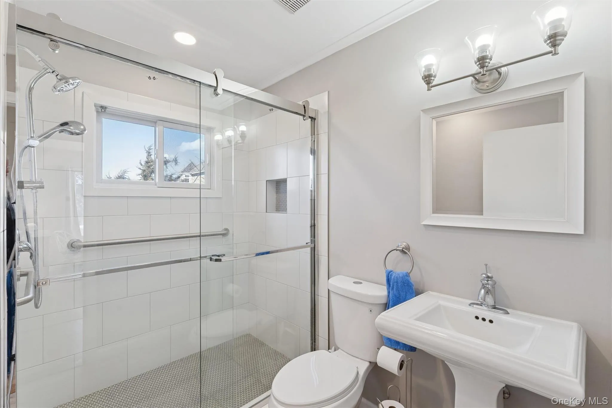 Full bath with a shower stall, toilet, and a sink Full bath with a shower stall, toilet, and a sink