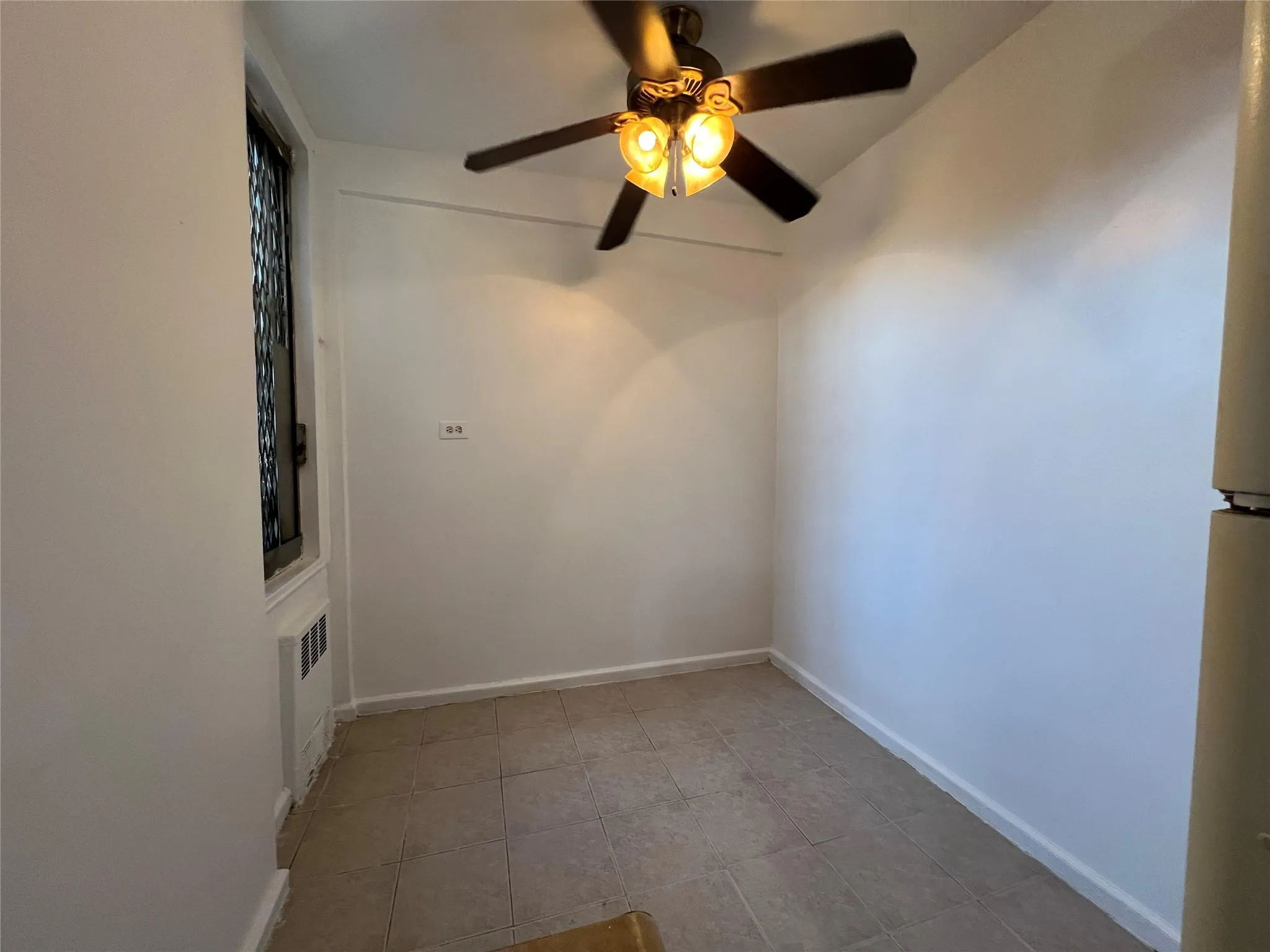 Unfurnished room with radiator and baseboards Unfurnished room with radiator and baseboards