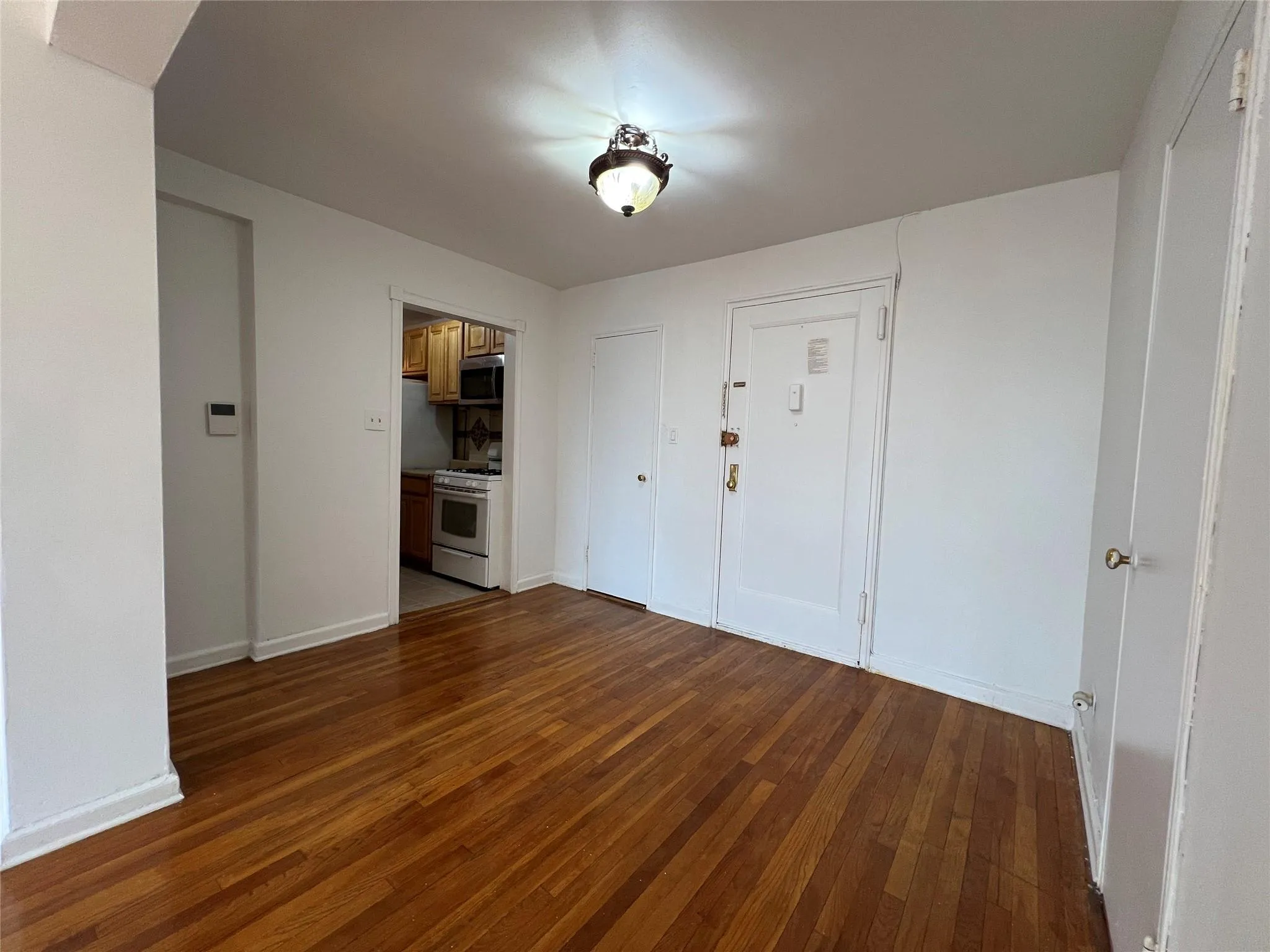 Empty room with baseboards and hardwood floors Empty room with baseboards and hardwood floors