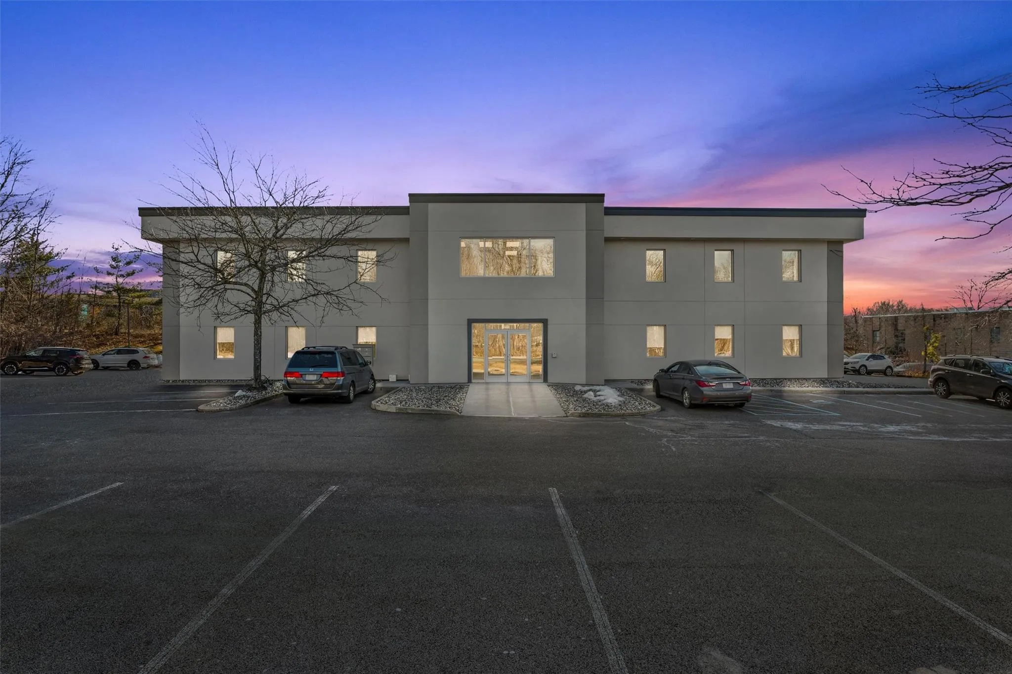 View of building exterior with uncovered parking View of building exterior with uncovered parking