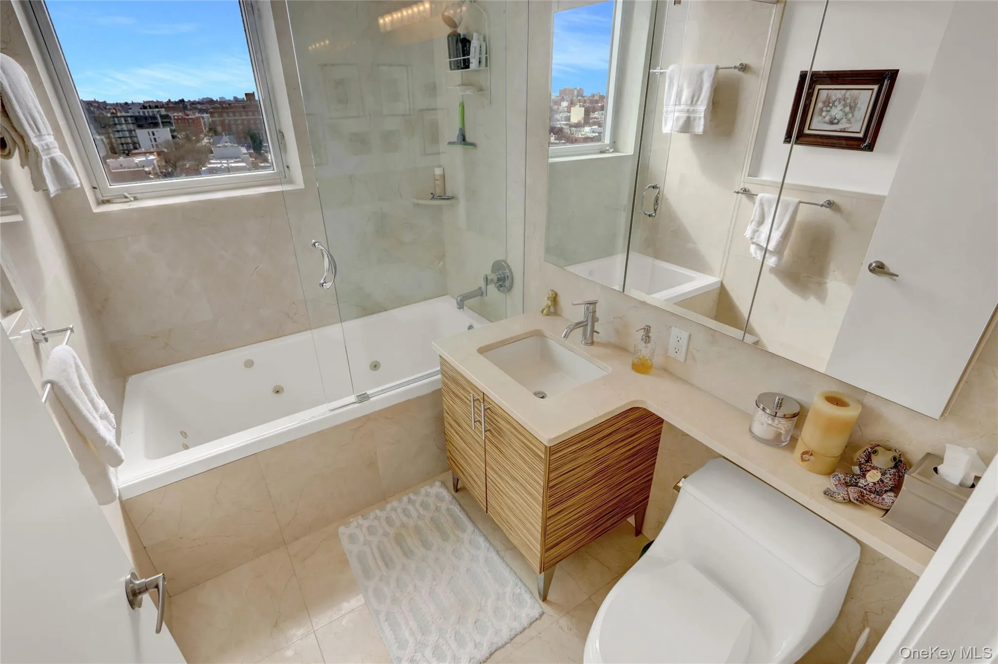 Bathroom with a wealth of natural light, toilet, and vanity Bathroom with a wealth of natural light, toilet, and vanity
