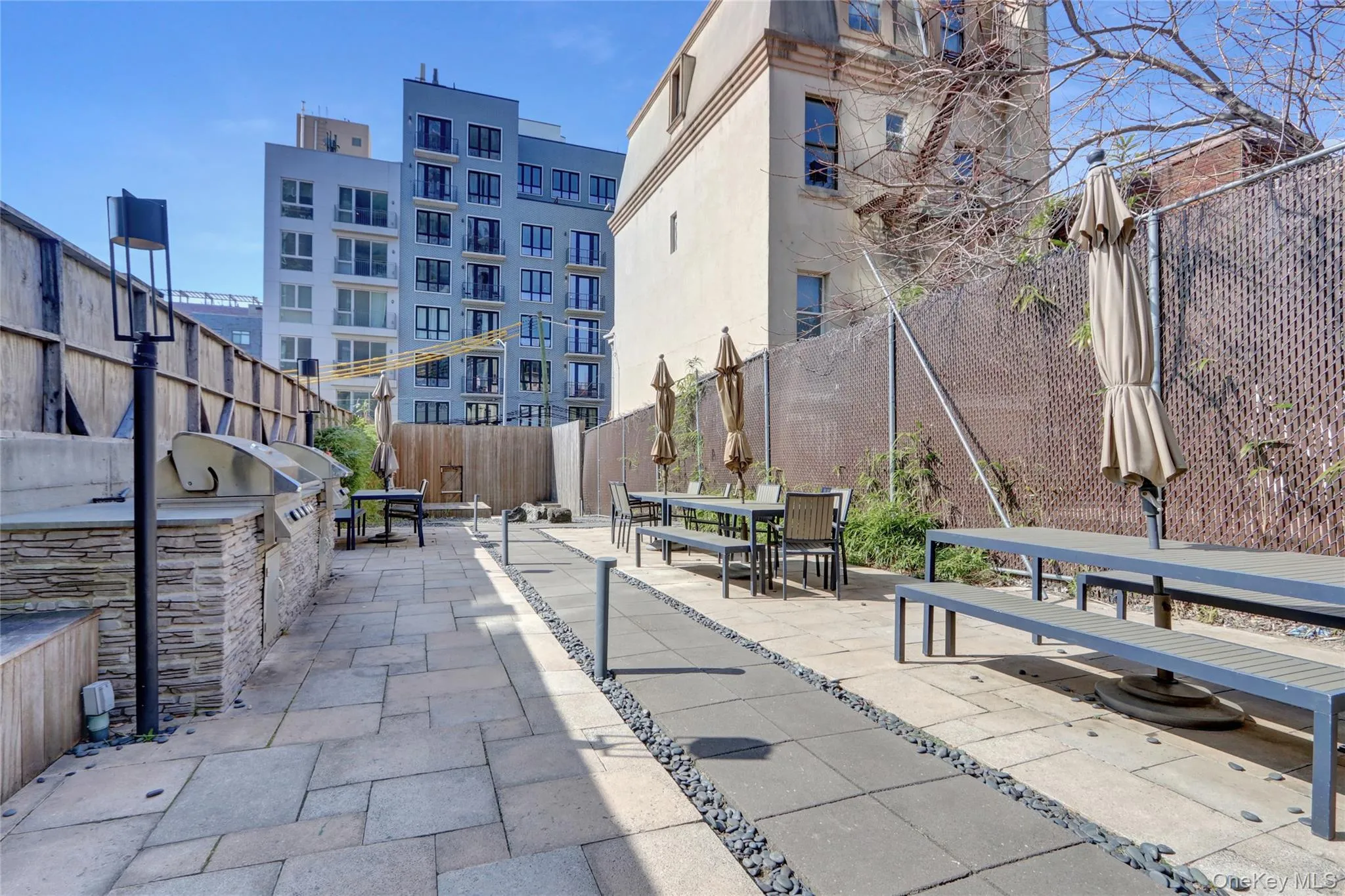 View of property's community featuring a patio, a fenced backyard, and an outdoor kitchen View of property's community featuring a patio, a fenced backyard, and an outdoor kitchen