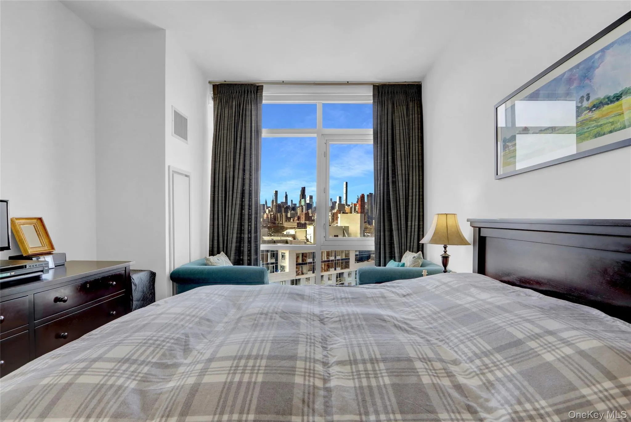 Bedroom featuring visible vents and a view of city Bedroom featuring visible vents and a view of city