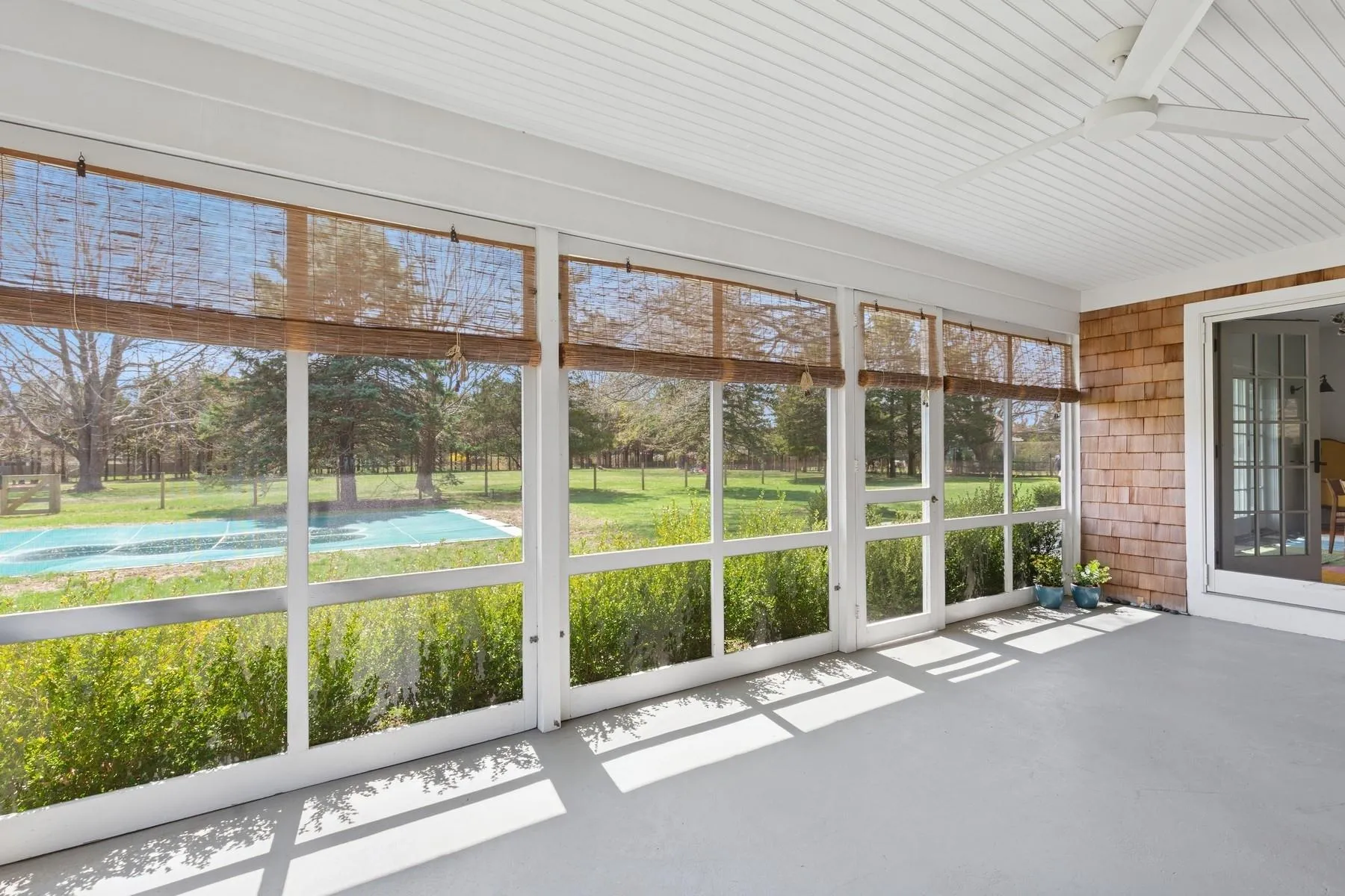 Unfurnished sunroom featuring a ceiling fan Unfurnished sunroom featuring a ceiling fan