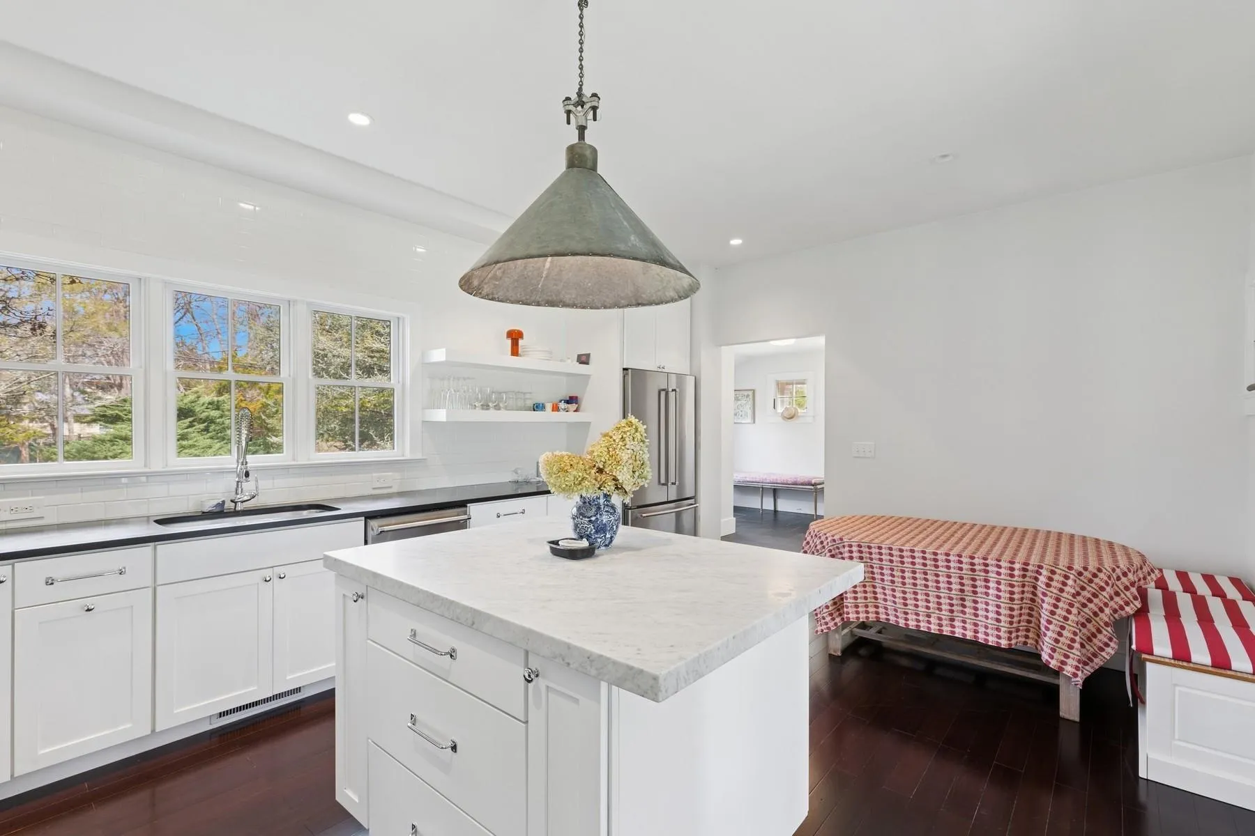 Kitchen with decorative backsplash, dark wood-style flooring, appliances with stainless steel finishes, and a sink Kitchen with decorative backsplash, dark wood-style flooring, appliances with stainless steel finishes, and a sink