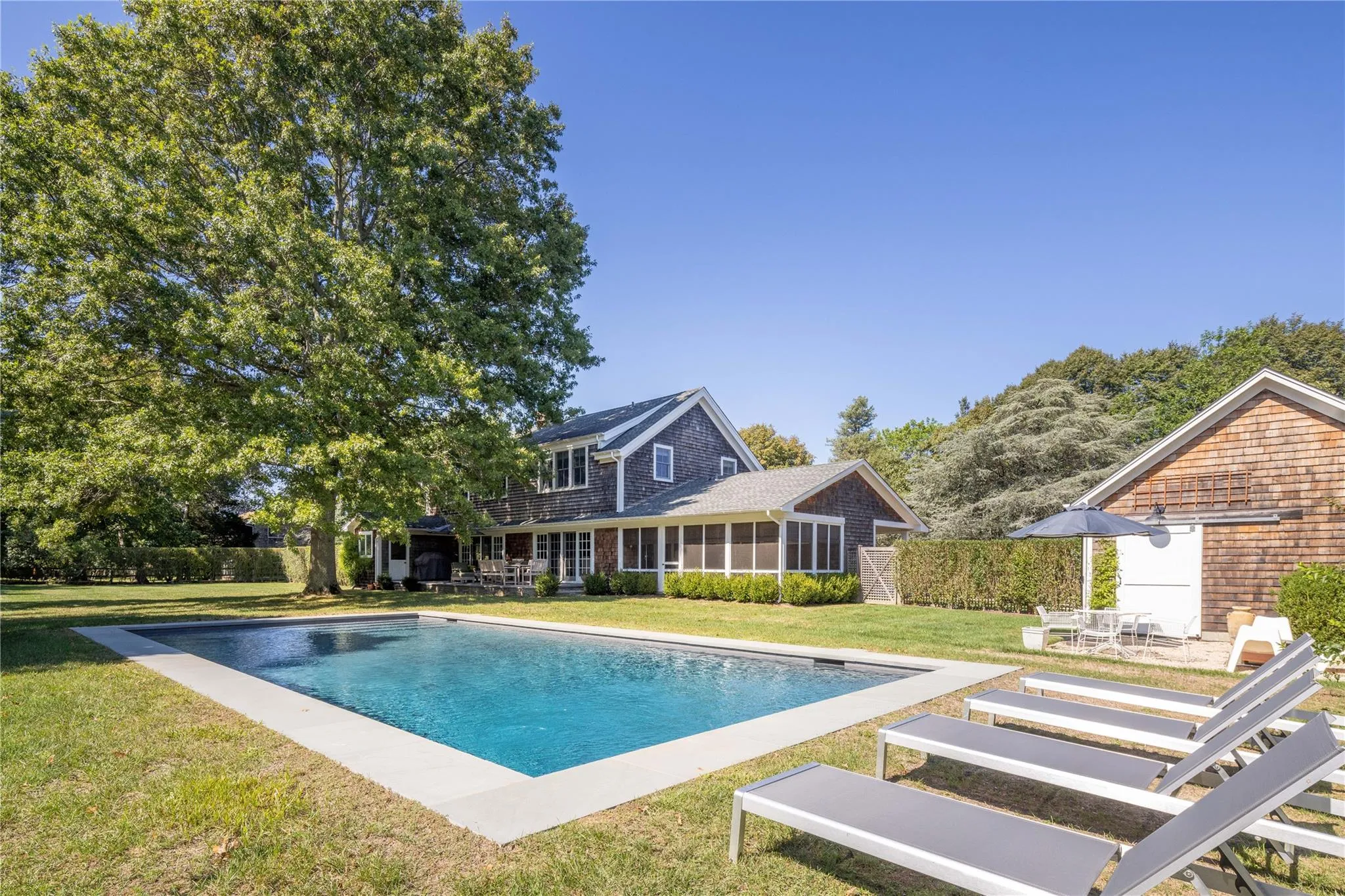 Pool with a patio area and a lawn Pool with a patio area and a lawn