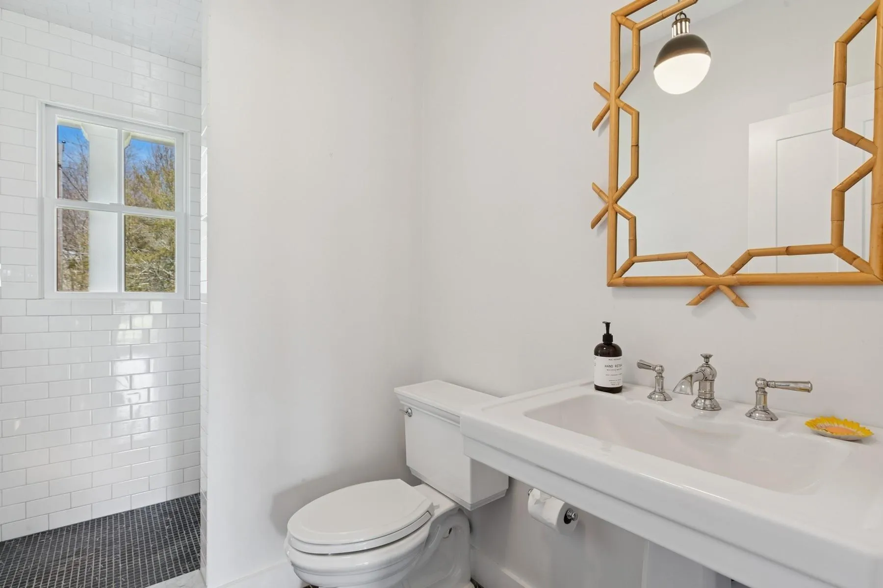 Bathroom with a tile shower, toilet, and a sink Bathroom with a tile shower, toilet, and a sink