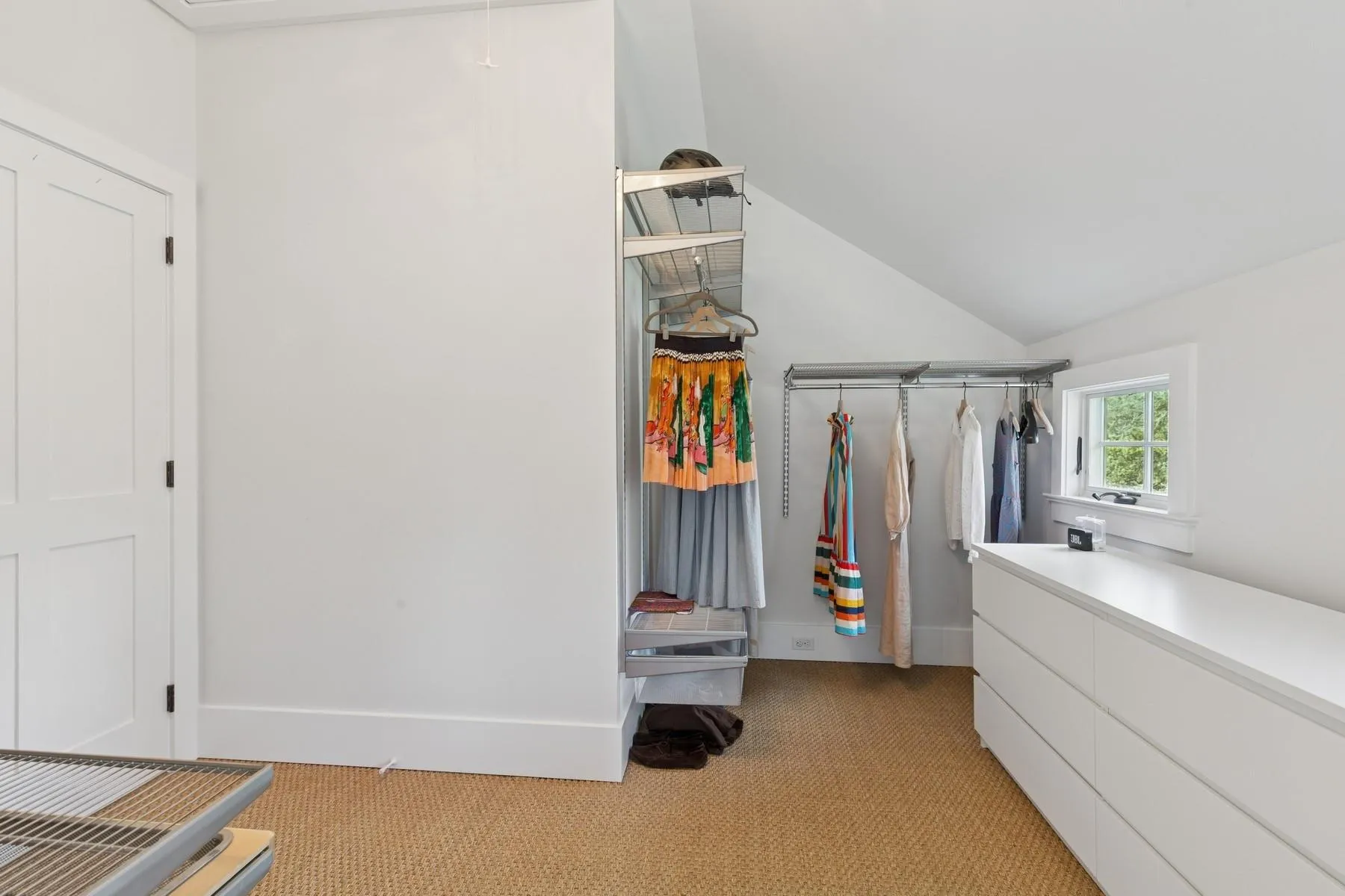 Spacious closet featuring lofted ceiling and light colored carpet Spacious closet featuring lofted ceiling and light colored carpet