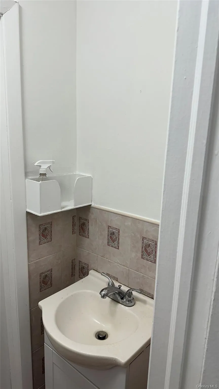 Bathroom featuring vanity and tile walls Bathroom featuring vanity and tile walls