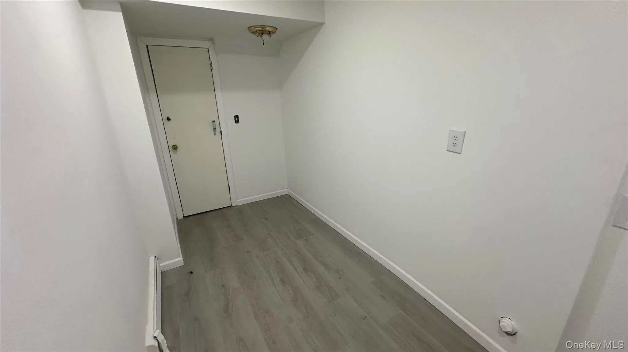 Hall with baseboards and light wood finished floors Hall with baseboards and light wood finished floors