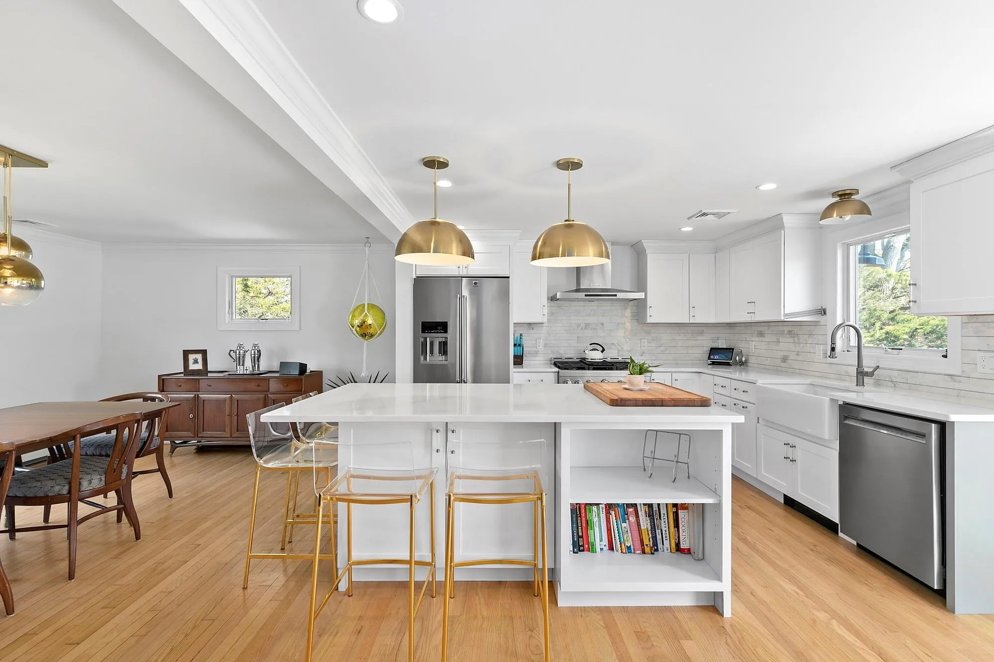 Kitchen featuring open shelves, ornamental molding, a sink, white cabinets, and appliances with stainless steel finishes Kitchen featuring open shelves, ornamental molding, a sink, white cabinets, and appliances with stainless steel finishes
