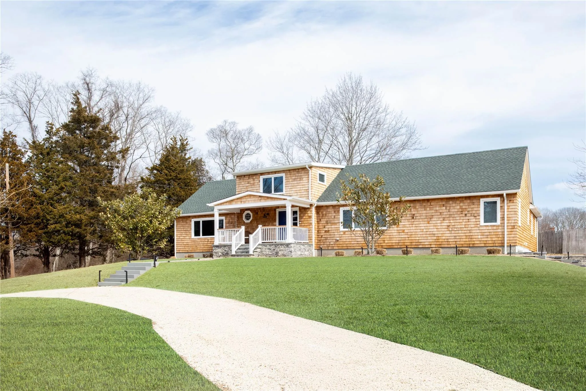 View of front of property featuring a porch, a shingled roof, and a front yard View of front of property featuring a porch, a shingled roof, and a front yard