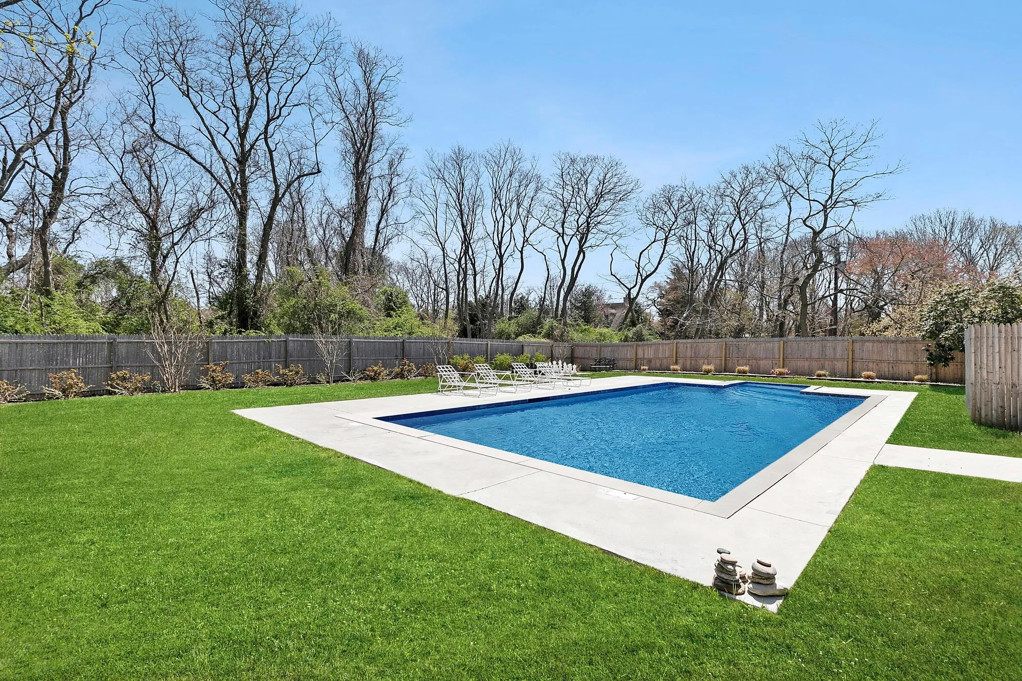 View of pool with a lawn, a patio, a fenced backyard, and a fenced in pool View of pool with a lawn, a patio, a fenced backyard, and a fenced in pool
