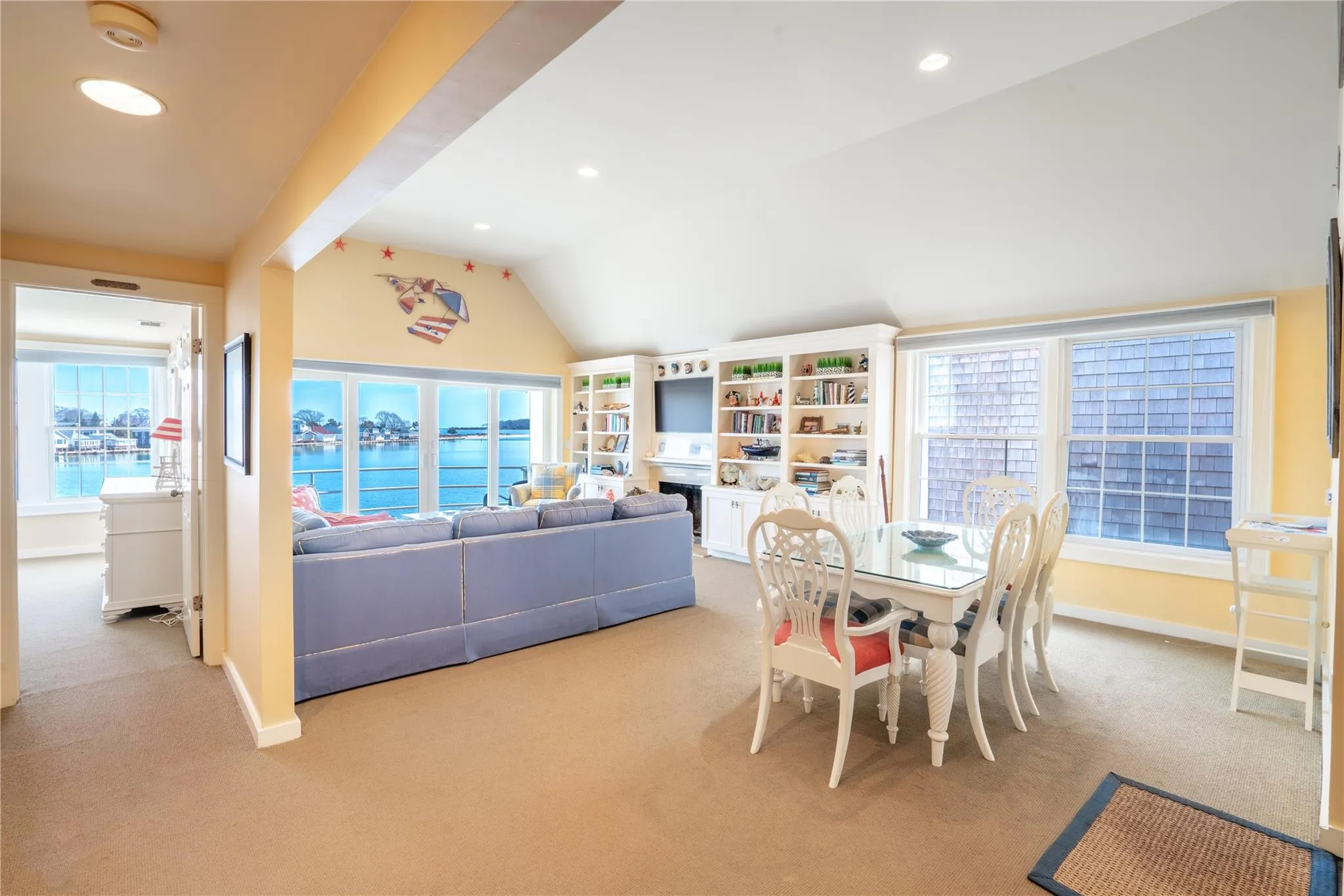 Dining space with carpet flooring, recessed lighting, baseboards, and lofted ceiling Dining space with carpet flooring, recessed lighting, baseboards, and lofted ceiling