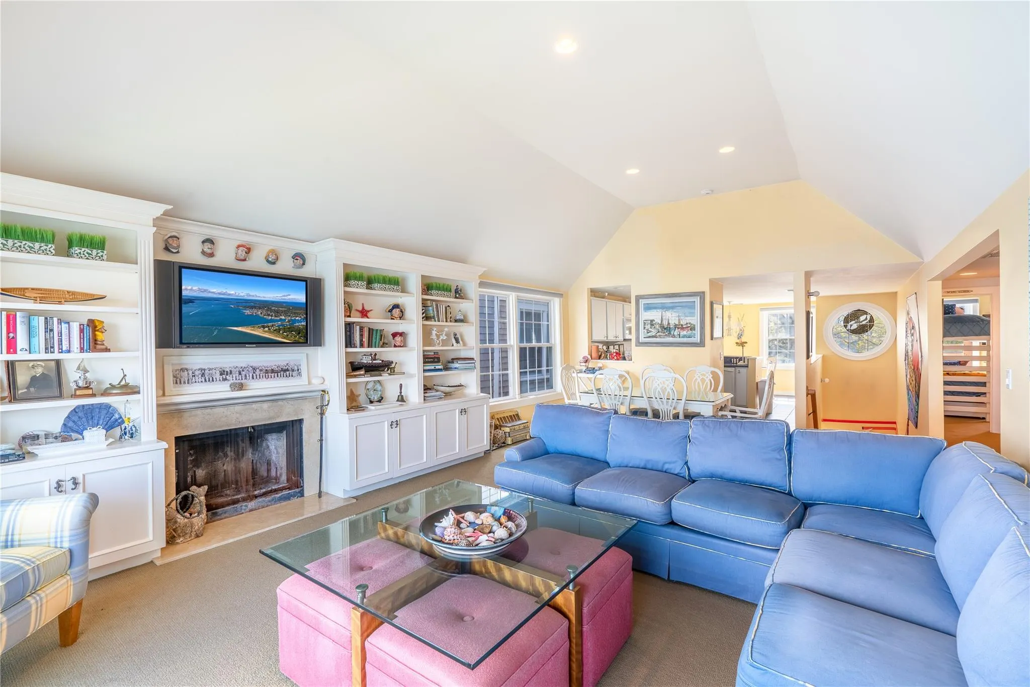 Living room with recessed lighting, a fireplace, lofted ceiling, and carpet floors Living room with recessed lighting, a fireplace, lofted ceiling, and carpet floors