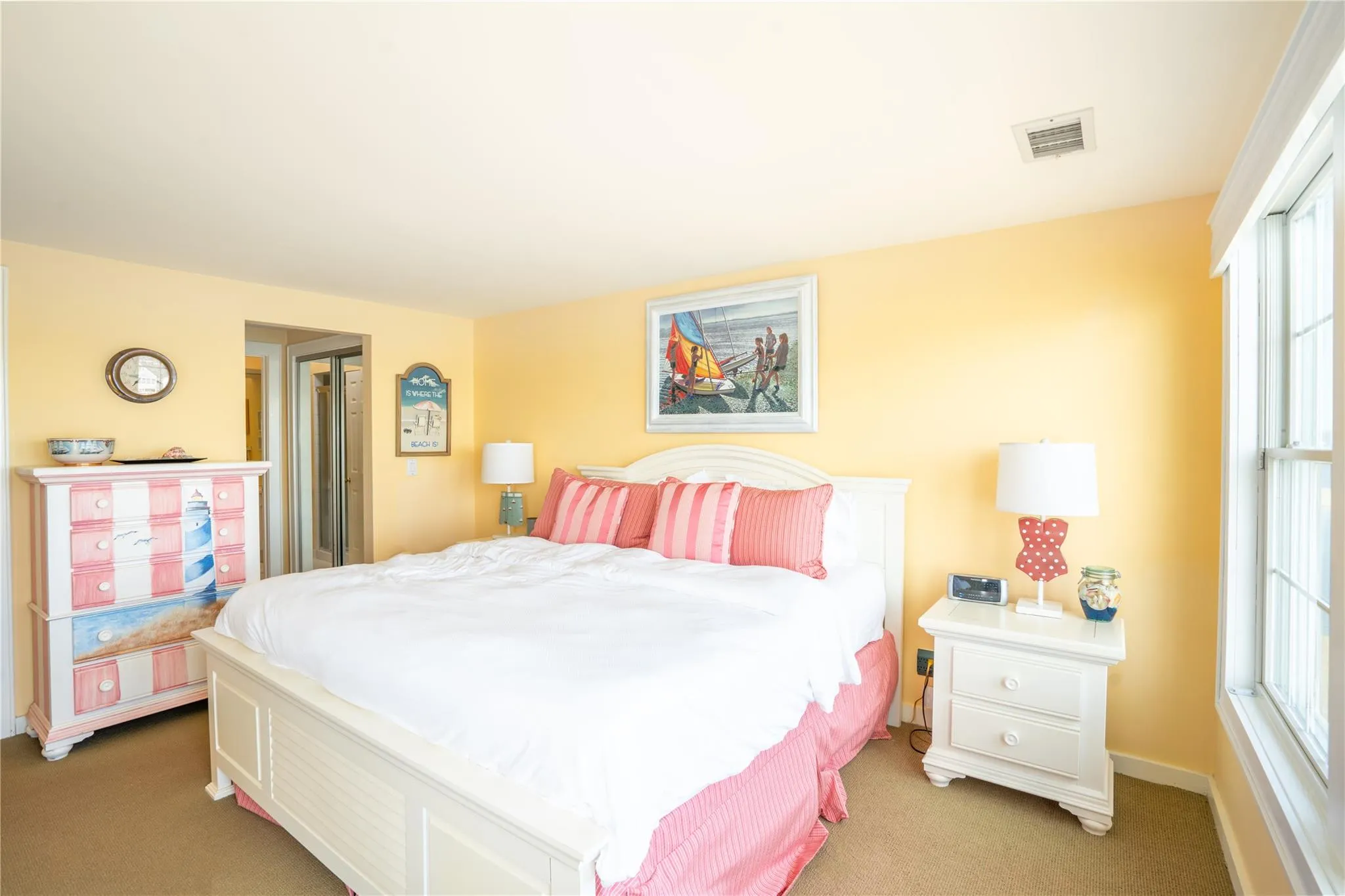 Bedroom featuring light colored carpet and visible vents Bedroom featuring light colored carpet and visible vents