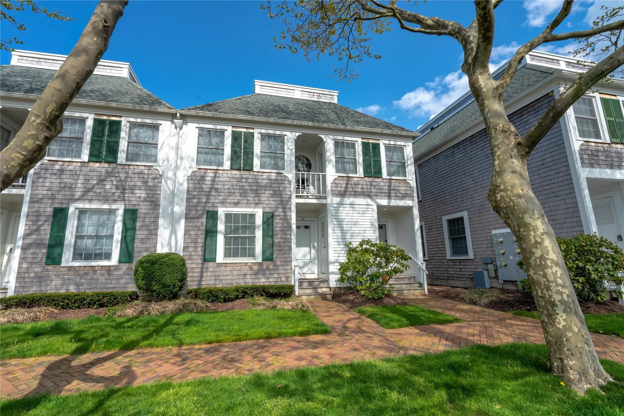 View of front of house featuring a balcony and a shingled roof View of front of house featuring a balcony and a shingled roof