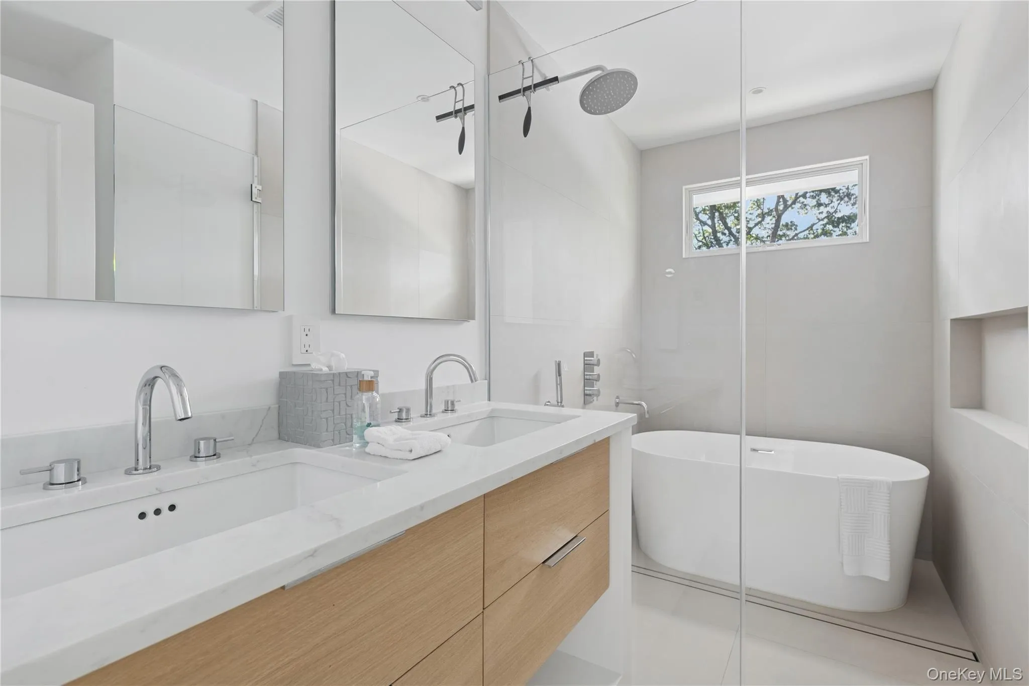 Full bathroom featuring double vanity, a freestanding bath, light tile patterned flooring, and walk in shower Full bathroom featuring double vanity, a freestanding bath, light tile patterned flooring, and walk in shower