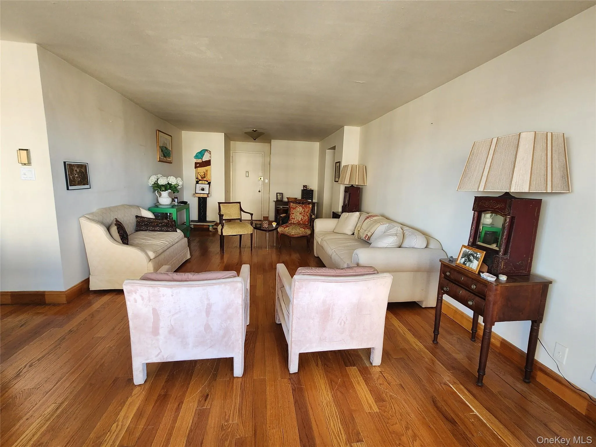 Living room featuring baseboards and hardwood / wood-style floors Living room featuring baseboards and hardwood / wood-style floors