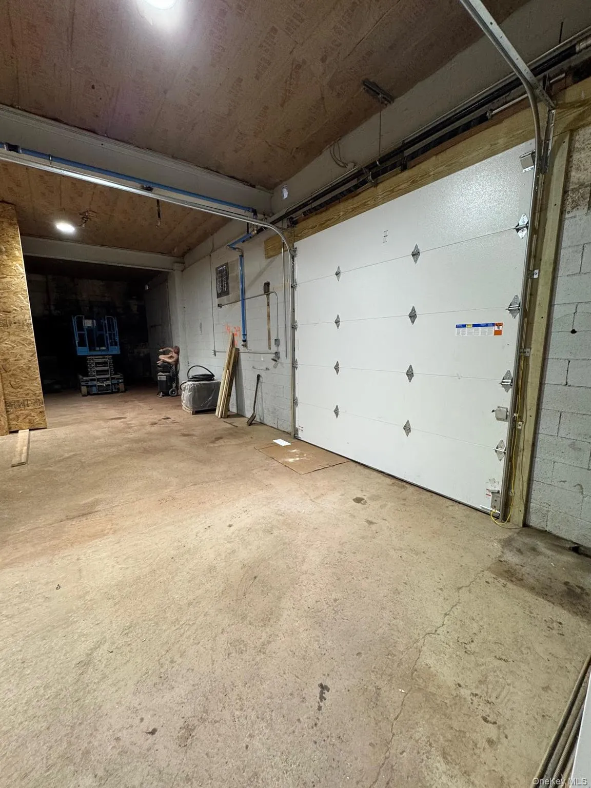 Garage featuring concrete block wall Garage featuring concrete block wall