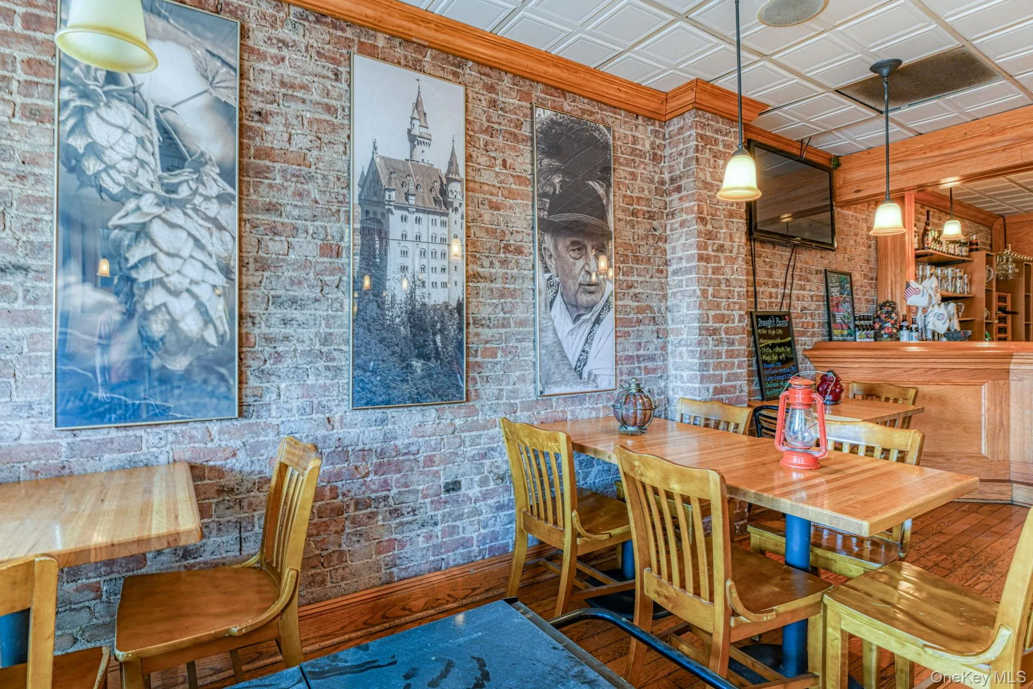Dining room with an ornate ceiling and brick wall Dining room with an ornate ceiling and brick wall