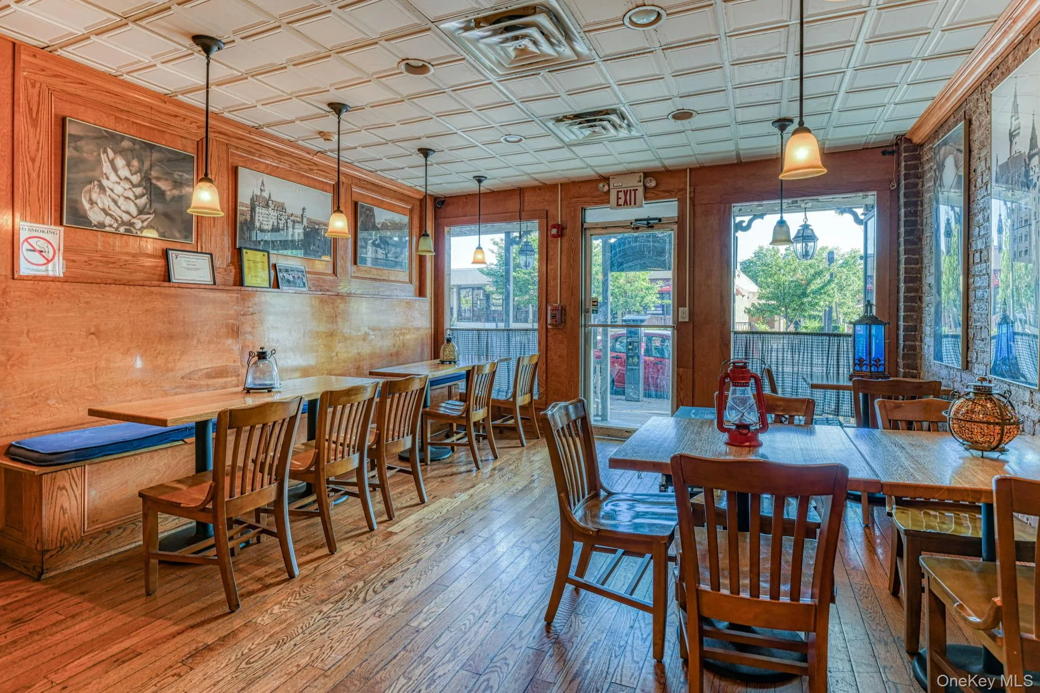 Dining room with visible vents, an ornate ceiling, a healthy amount of sunlight, and hardwood / wood-style floors Dining room with visible vents, an ornate ceiling, a healthy amount of sunlight, and hardwood / wood-style floors