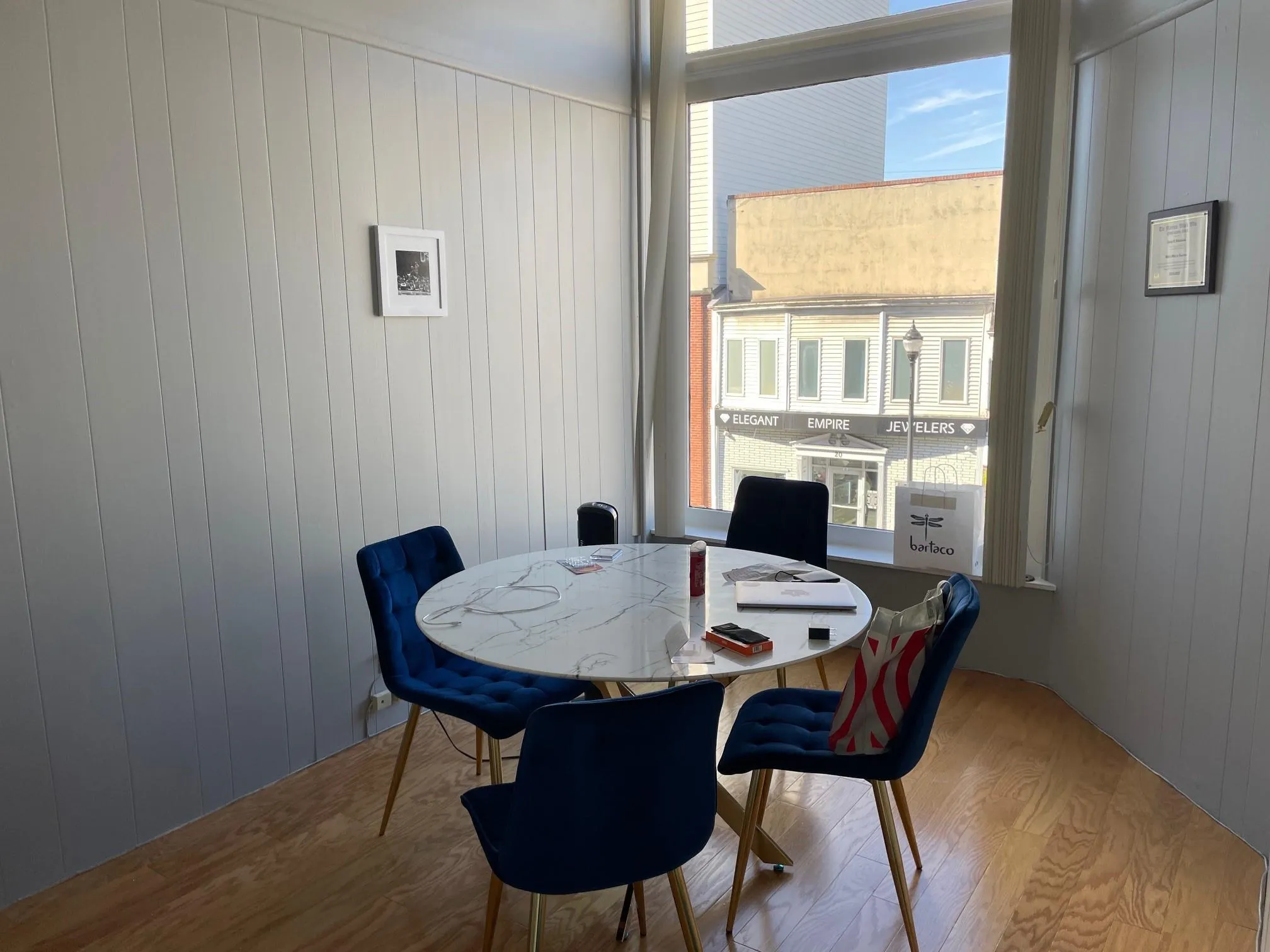 Dining space with wood finished floors, wood walls, and plenty of natural light Dining space with wood finished floors, wood walls, and plenty of natural light