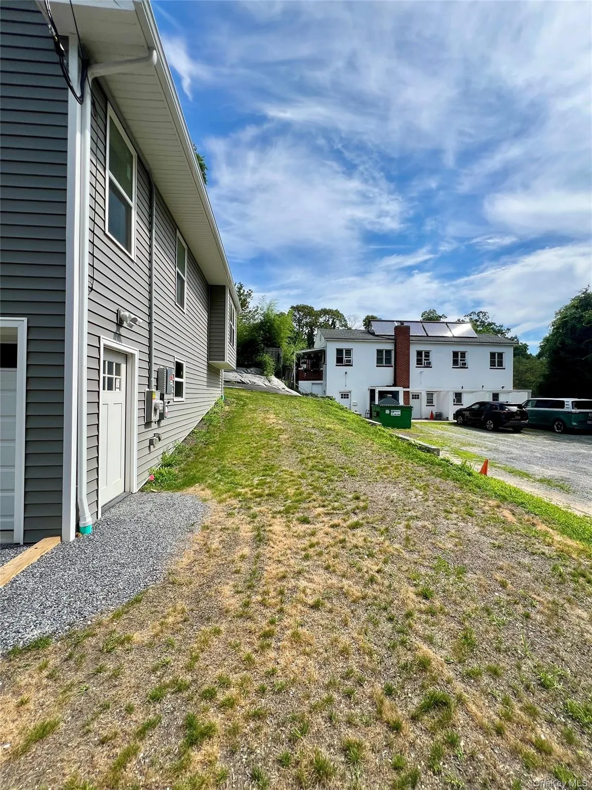 View of side yard with side door entrance with electric keypad lock. View of side yard with side door entrance with electric keypad lock.