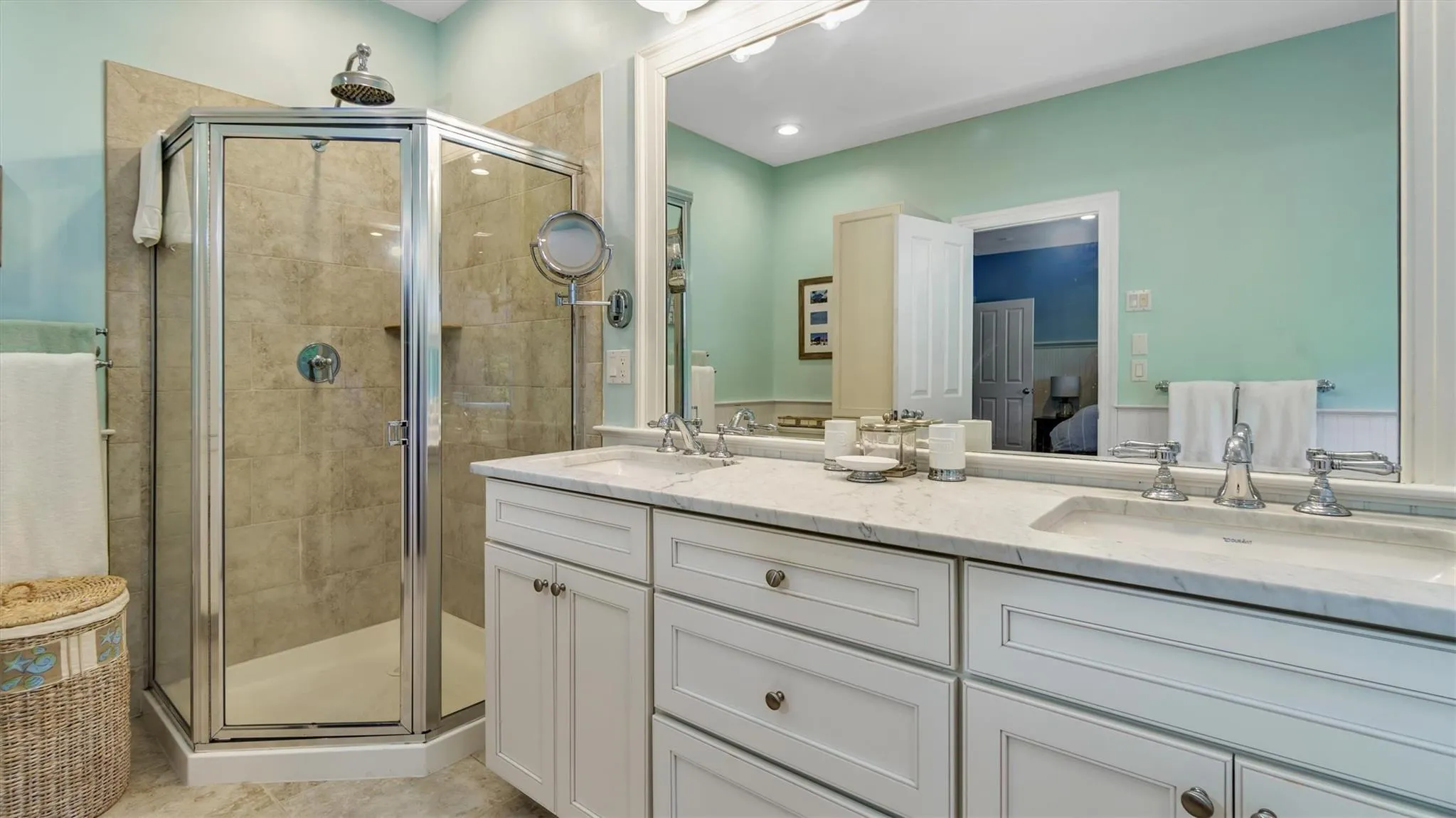 Full bath featuring ensuite bath, double vanity, a shower stall, and a sink Full bath featuring ensuite bath, double vanity, a shower stall, and a sink