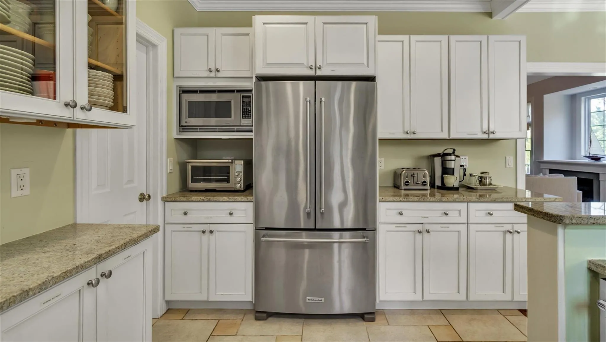 Kitchen with stainless steel appliances, white cabinets, crown molding, and a toaster Kitchen with stainless steel appliances, white cabinets, crown molding, and a toaster