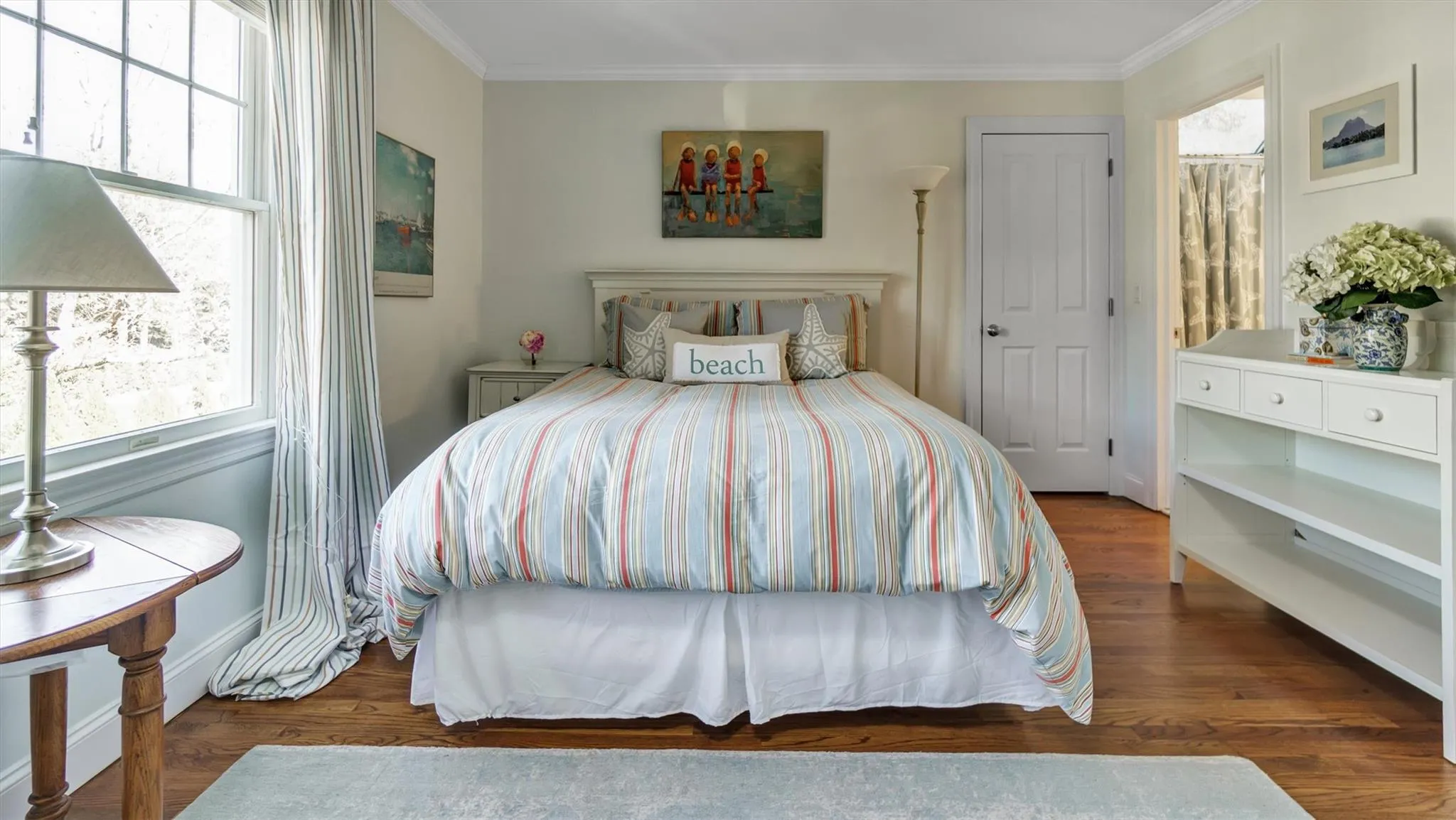 Bedroom featuring baseboards, wood finished floors, and crown molding Bedroom featuring baseboards, wood finished floors, and crown molding