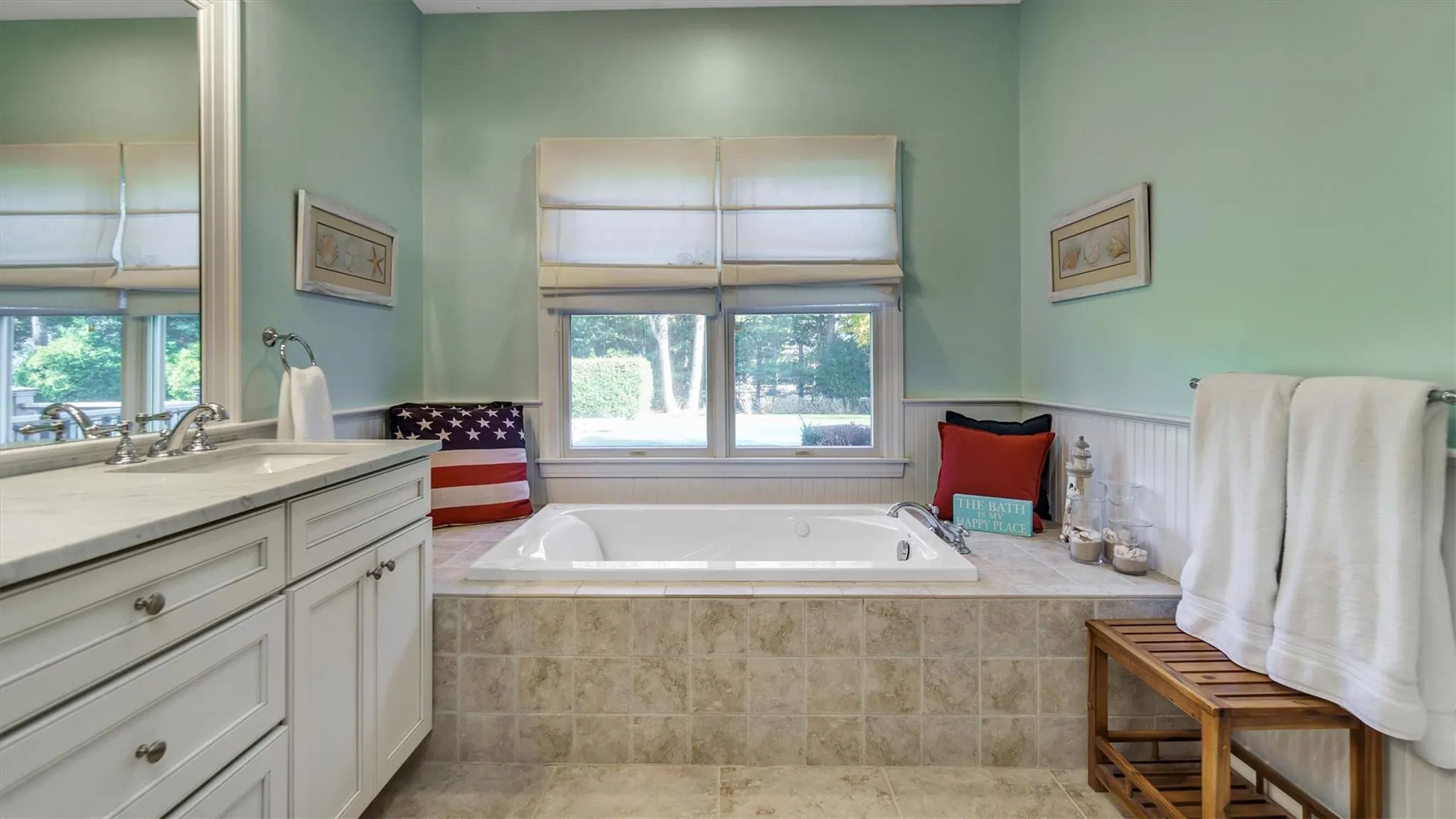 Bathroom with vanity, a garden tub, tile patterned flooring, and wainscoting Bathroom with vanity, a garden tub, tile patterned flooring, and wainscoting
