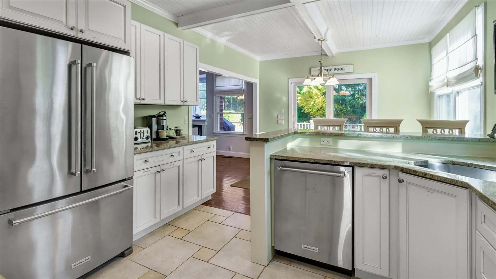 Kitchen featuring a sink, appliances with stainless steel finishes, white cabinets, and crown molding Kitchen featuring a sink, appliances with stainless steel finishes, white cabinets, and crown molding