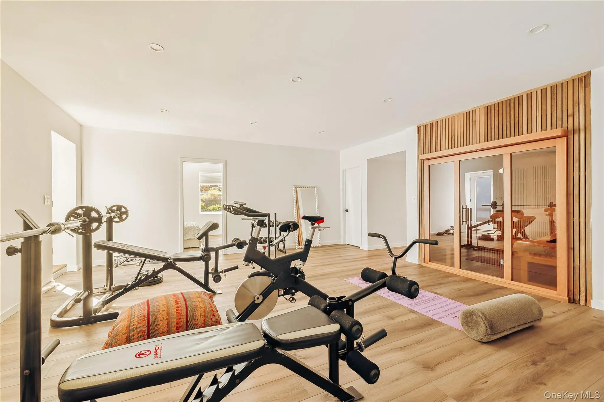Exercise room featuring recessed lighting and light wood finished floors Exercise room featuring recessed lighting and light wood finished floors